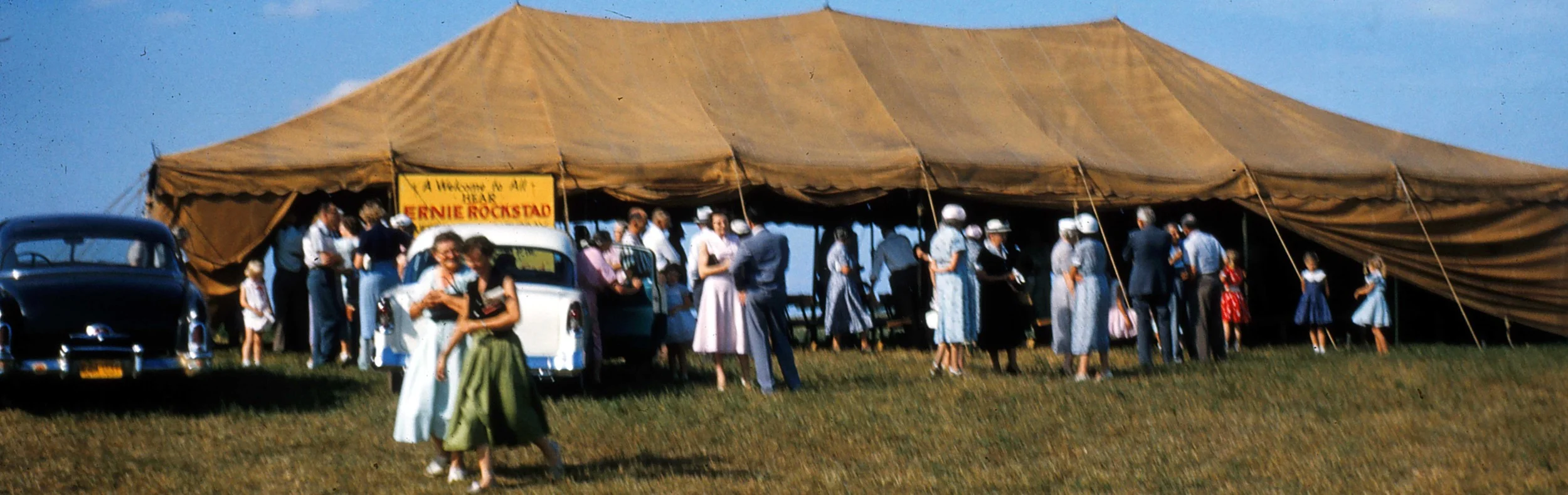 Guests departing after one of Pastor Ernie's many packed tent meetings.