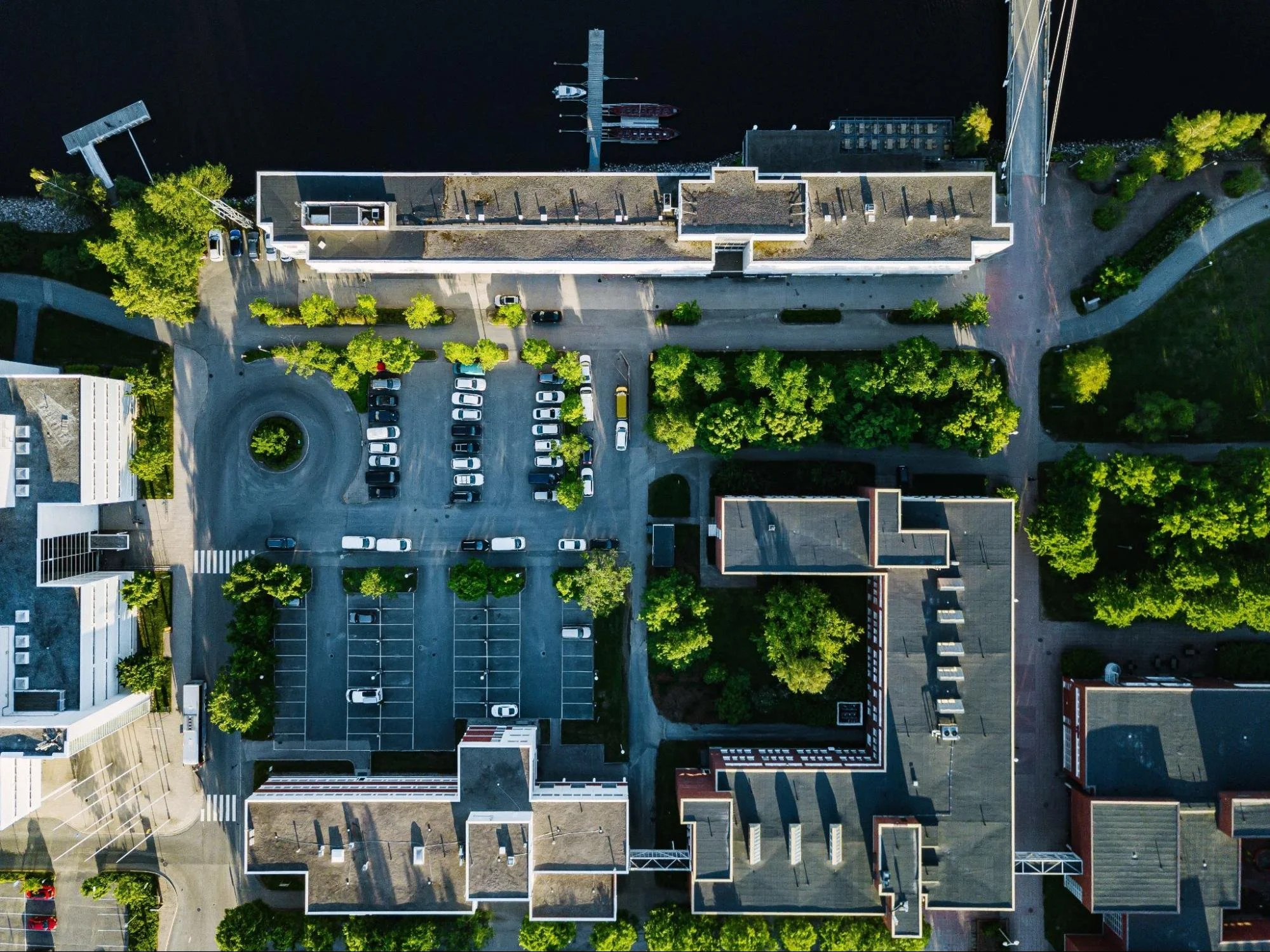 Aerial view of urban buildings with organized parking areas and visible vehicle layout