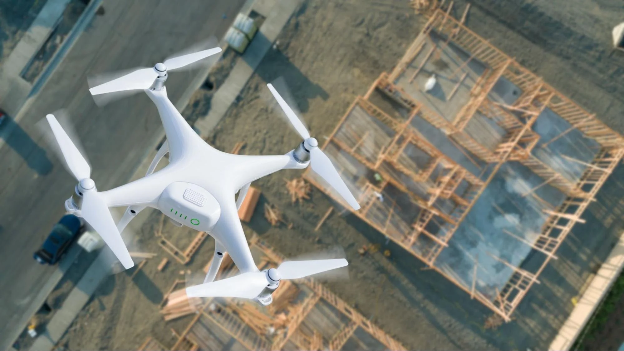 A drone inspecting a construction site for mapping, measurements, and progress tracking