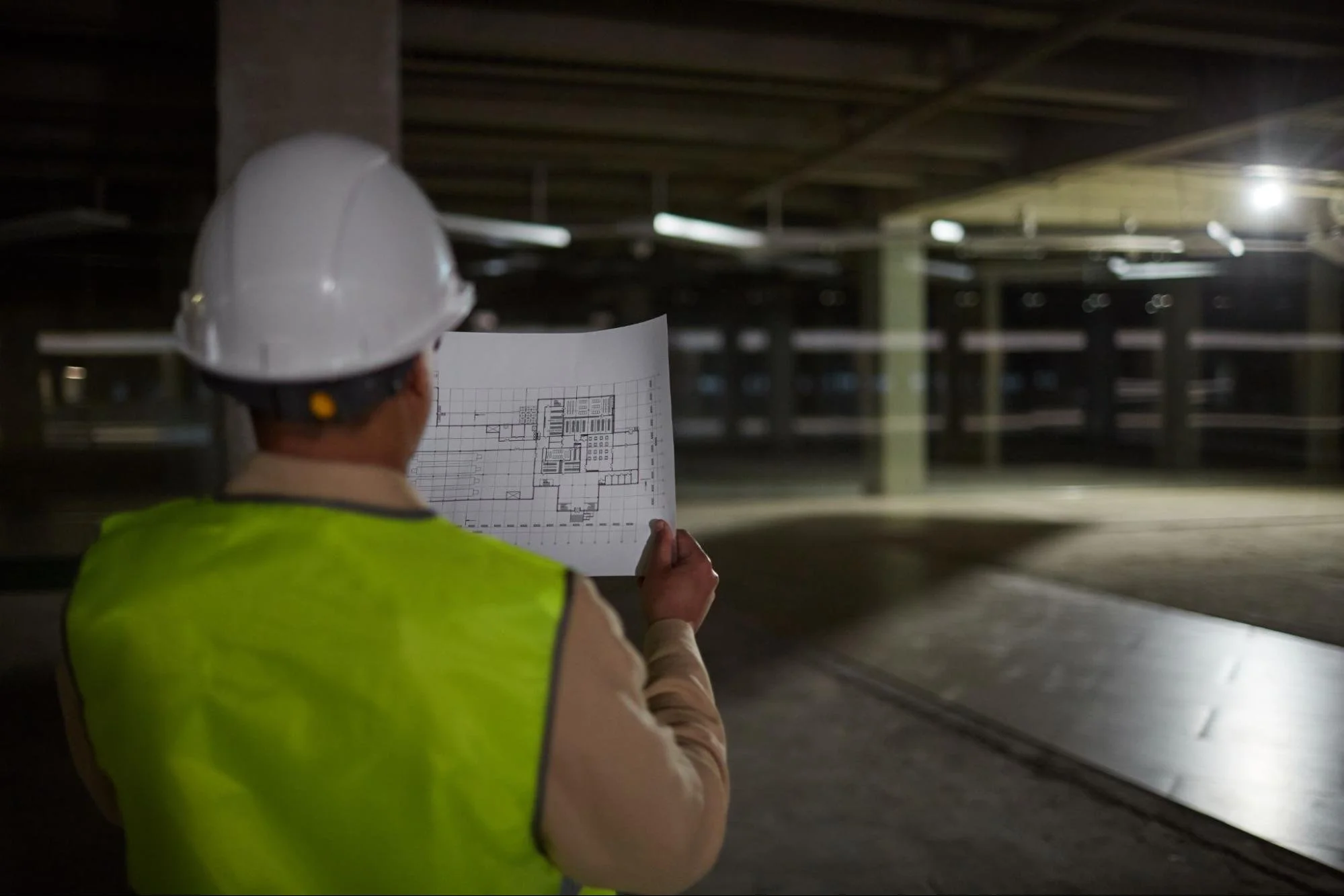 An engineer inspecting building foundations during an as-built survey for project verification