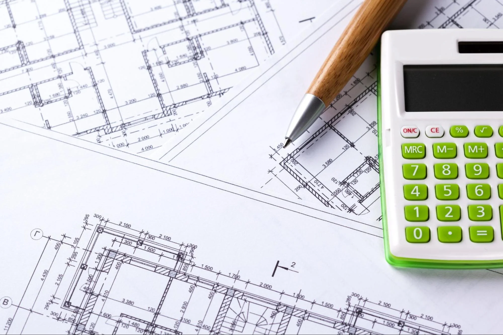 Square footage marked on a piece of paper next to a pen and a calculator.