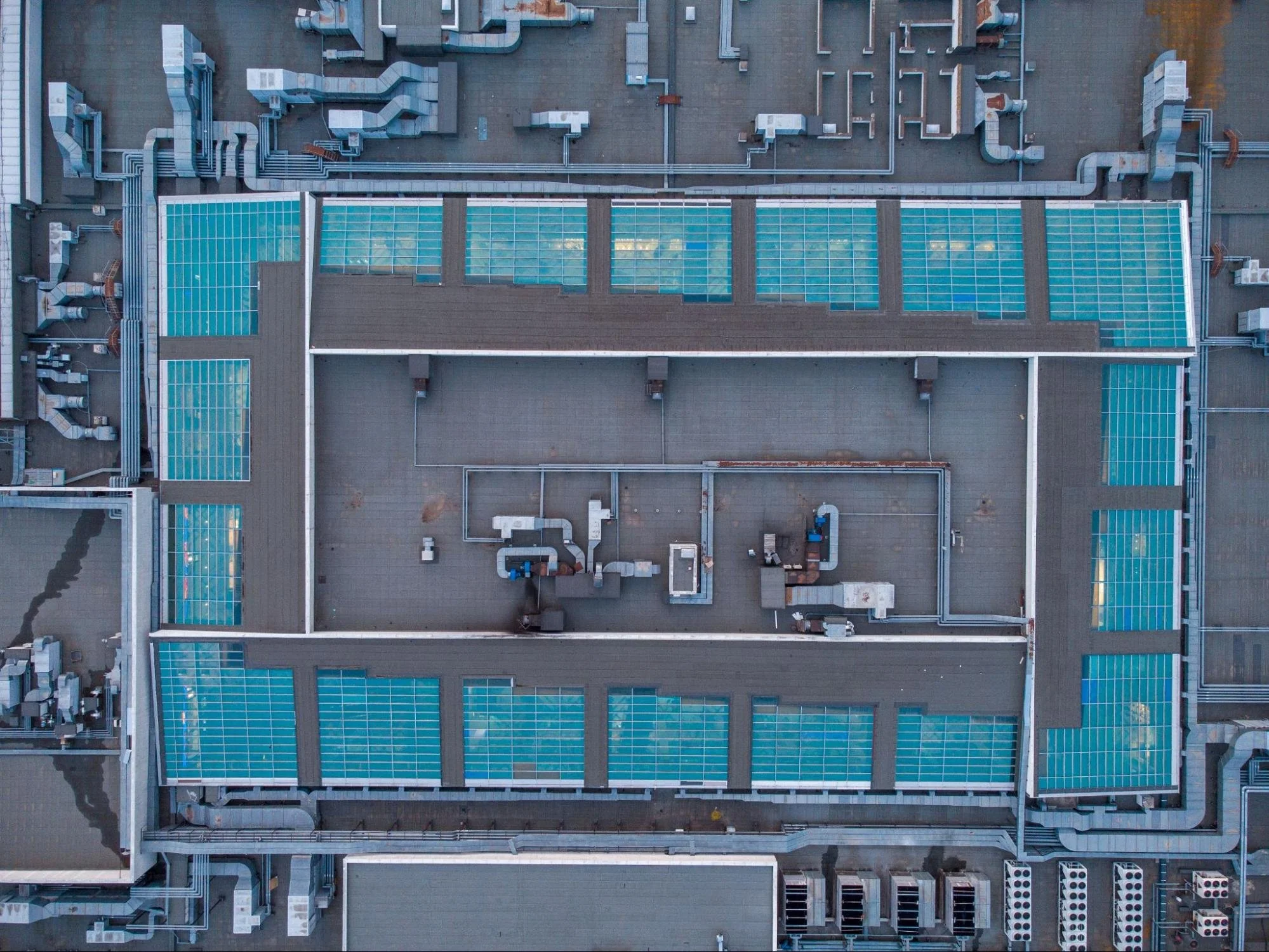 Aerial drone photography of a large shopping center roof illustrating building footprint and roof design
