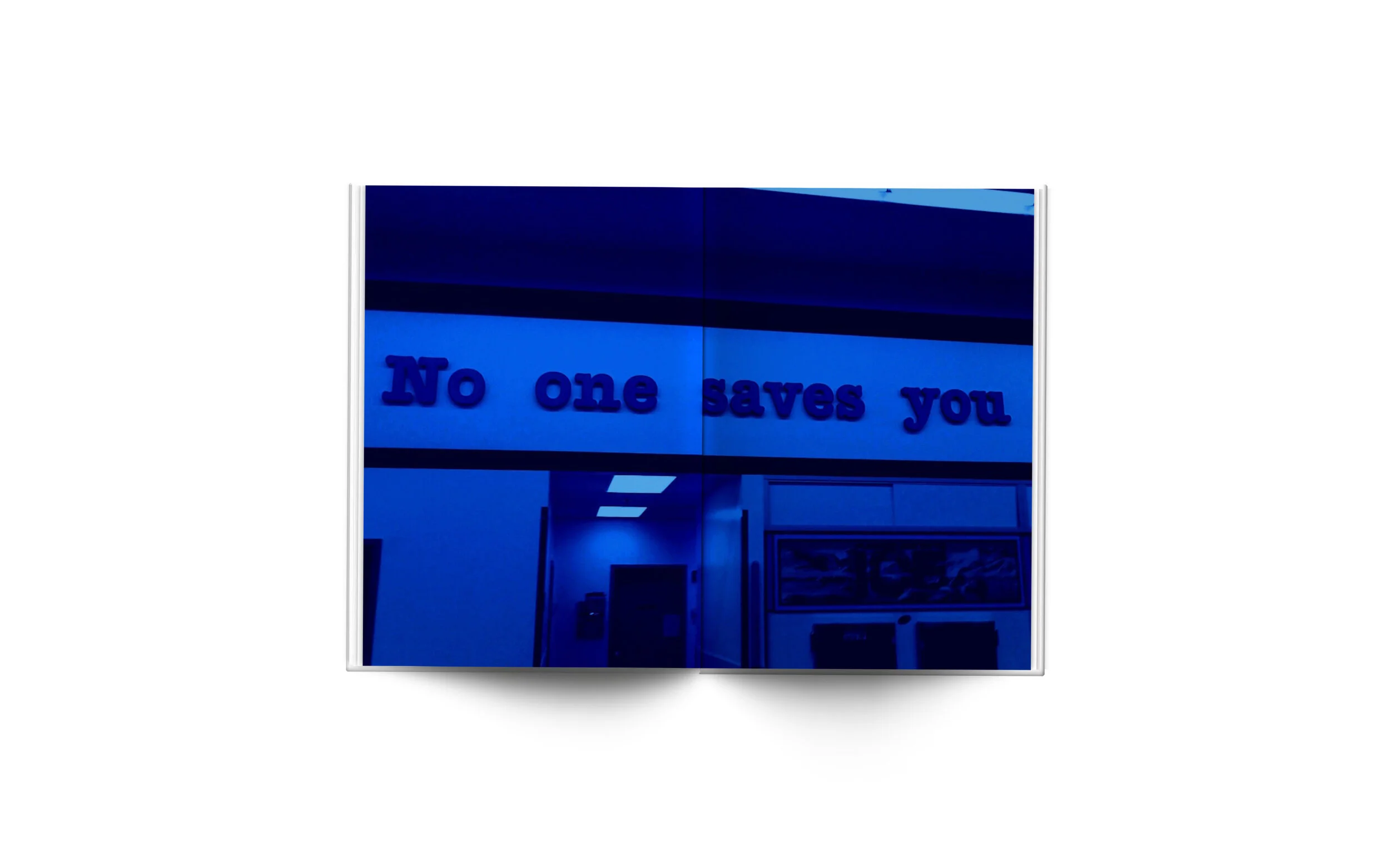The image shows a building with a sign that says 'No one saves you' in blue letters.