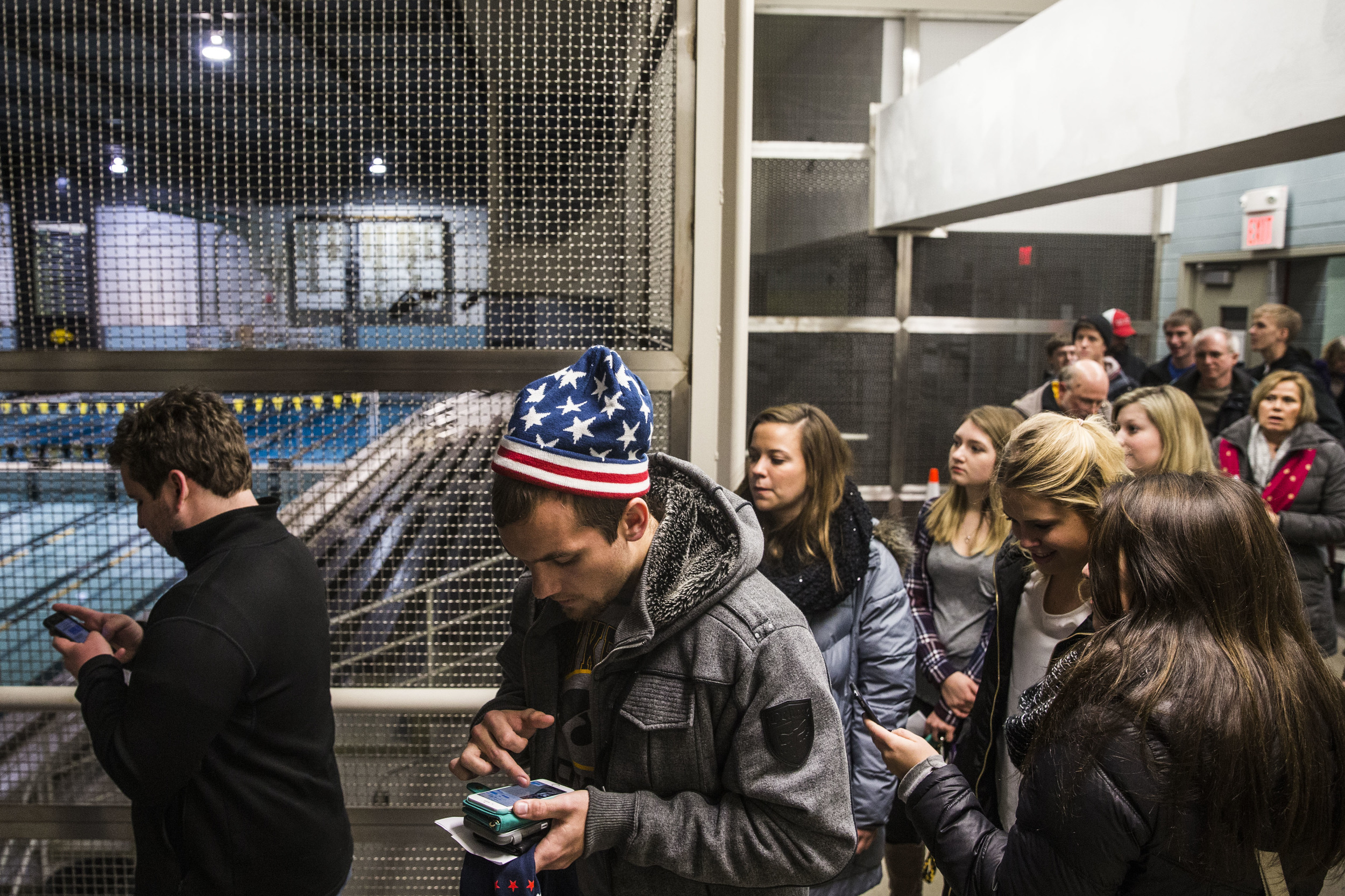 People stand in a line to attend Donald Trump's rally in Iowa City