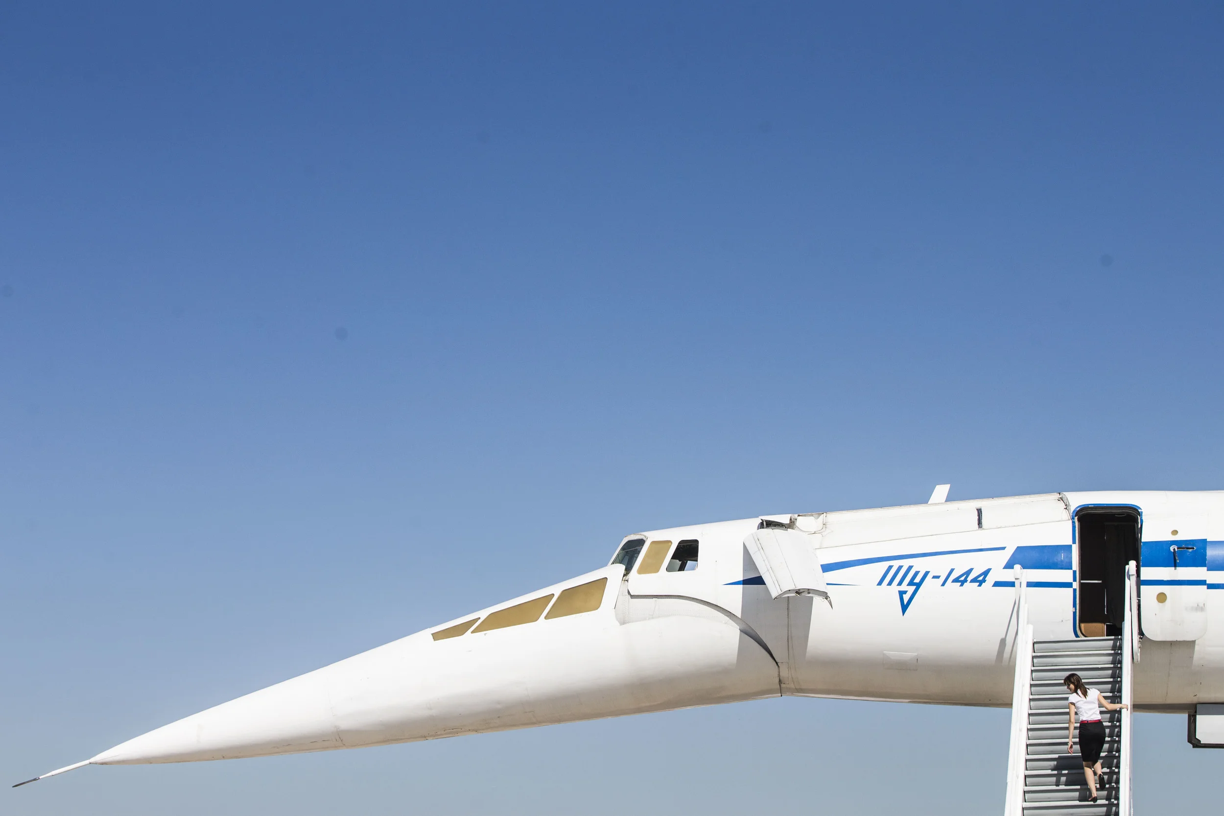 A woman and a TU-144, world's first supersonic jet airliner, a part of an expo at MAKS airshow near Moscow. August 25, 2015