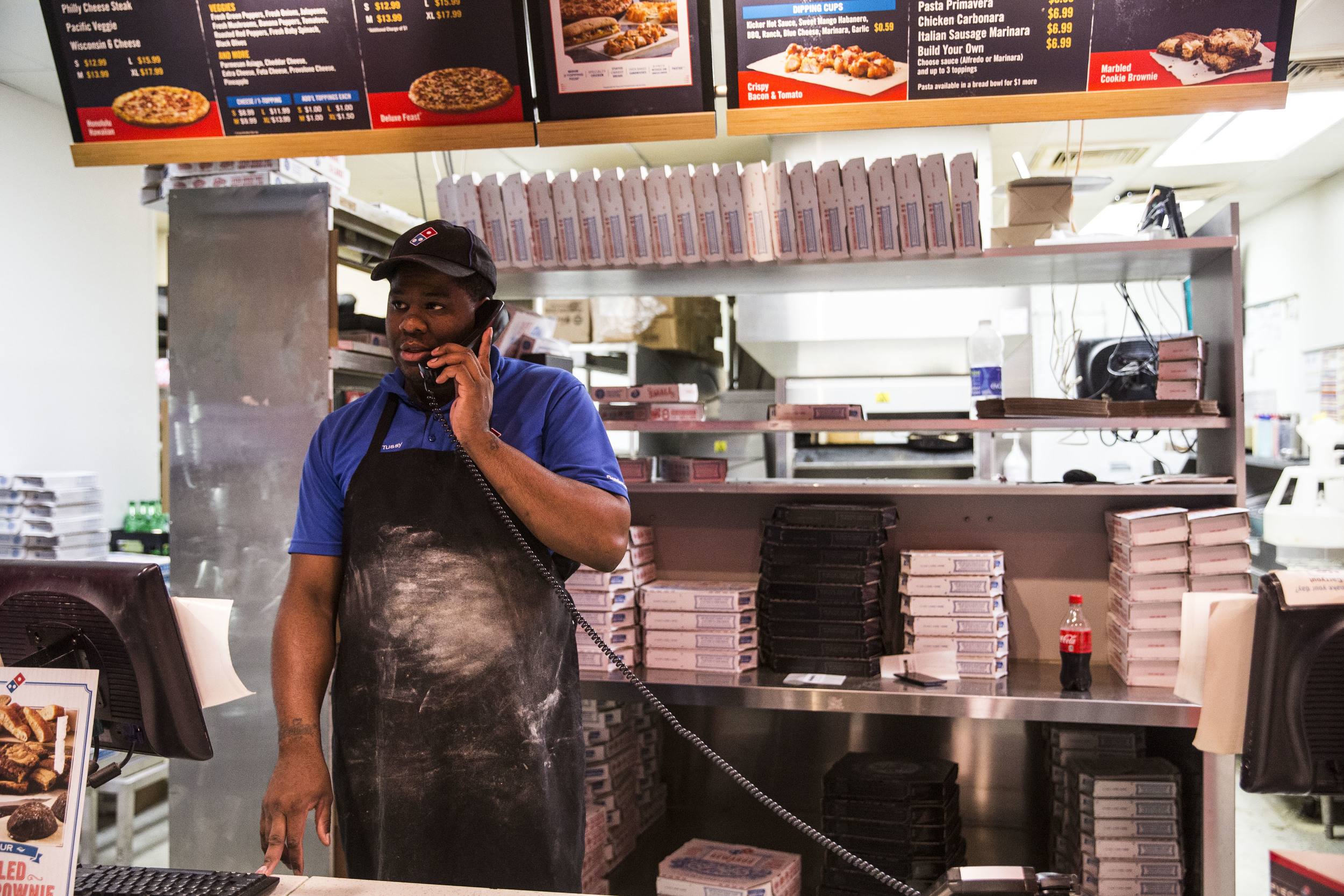 A man works a night shift in a pizzeria