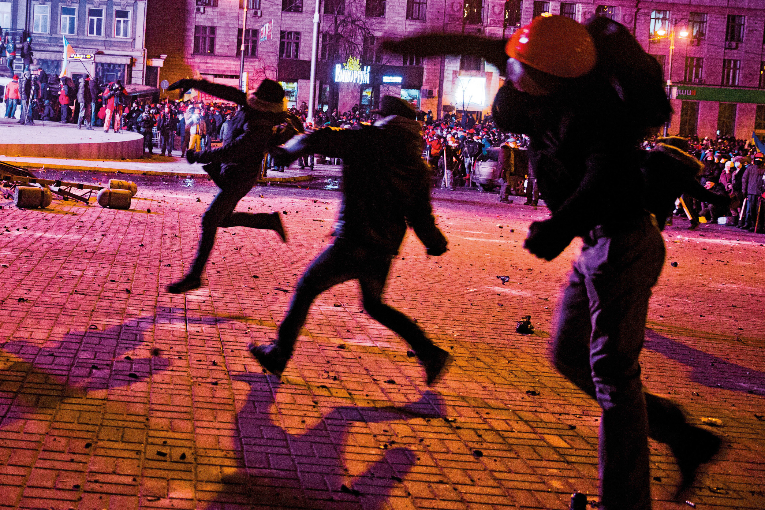  Protesters throw stones towards riot police forces 