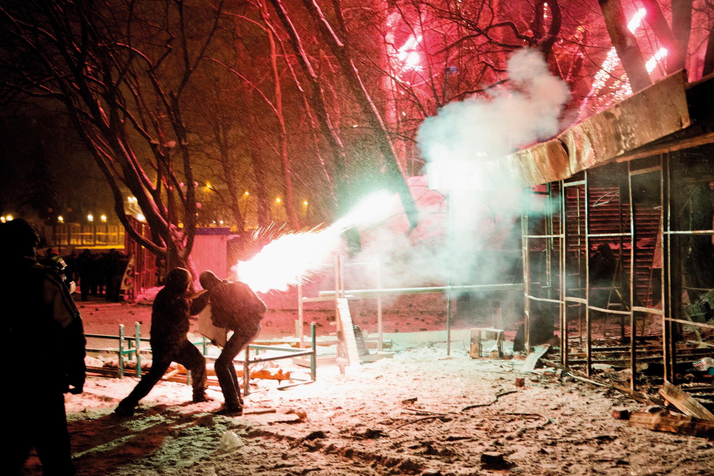  Protesters shoot with fireworks towards riot police forces 