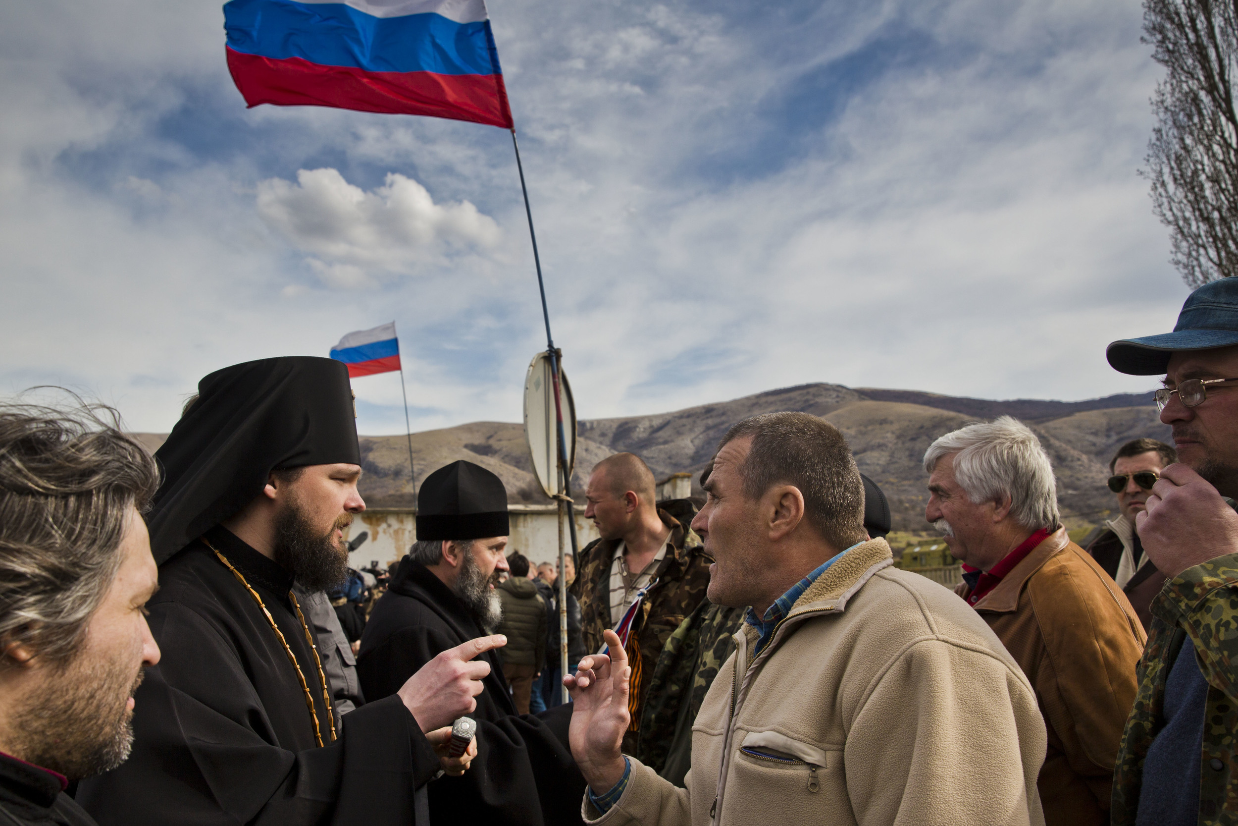 Pro-Russian militiamen are seen confronting a priest on his way to a church situated on Ukrainian military base