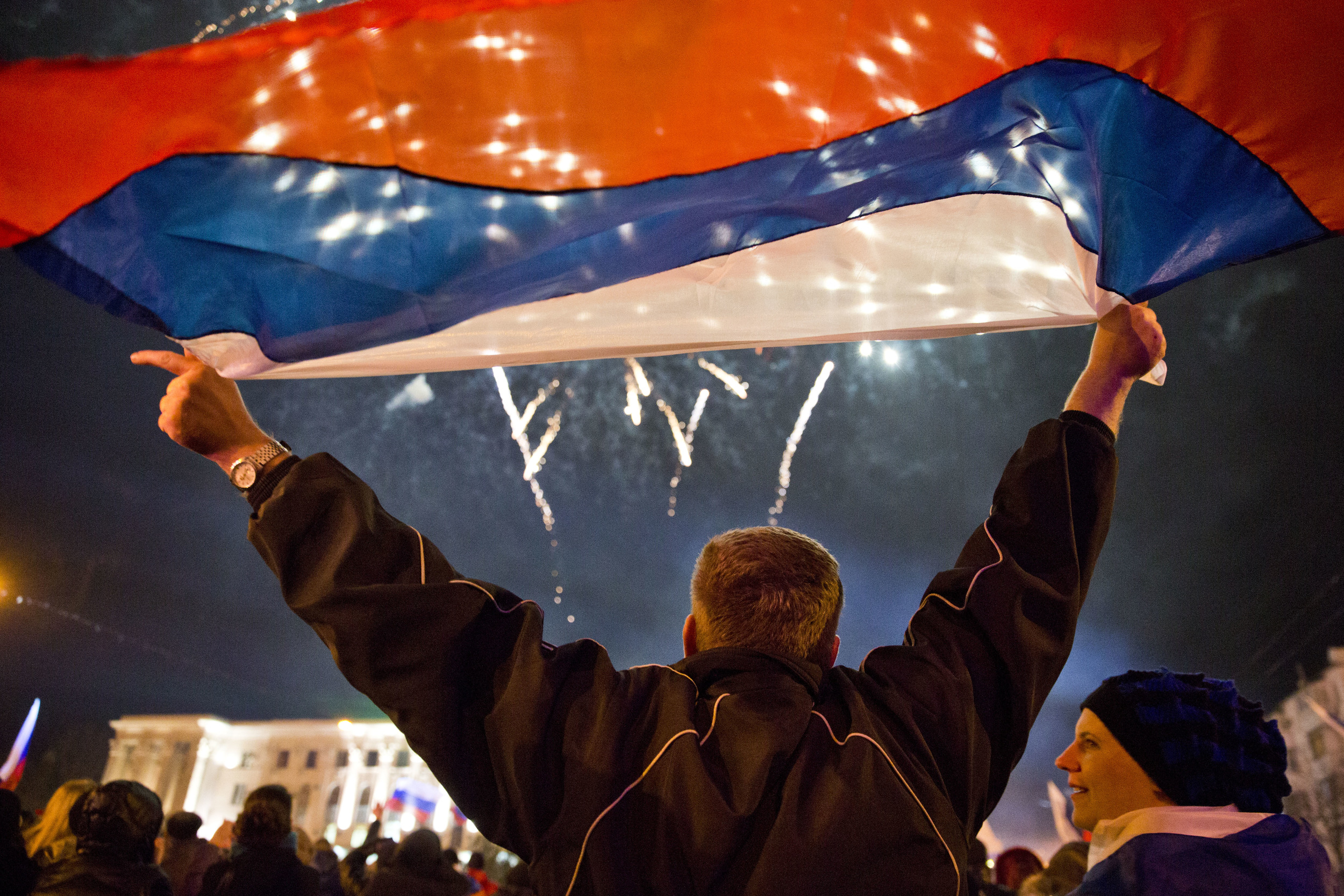  A man is seen holding Russian flag as Simferopol celebrates Crimea becoming a part of Russia 