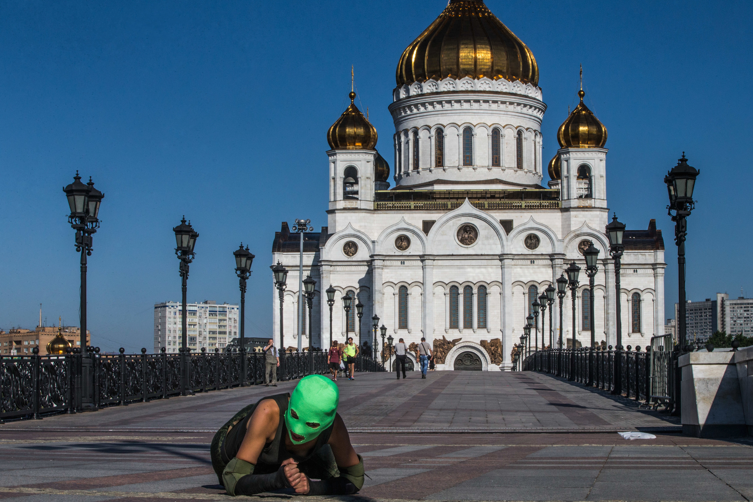 A member of Pussy Riot crawls past the Cathedral of Christ the Savior.  The band was arrested here following a performance in 2012.