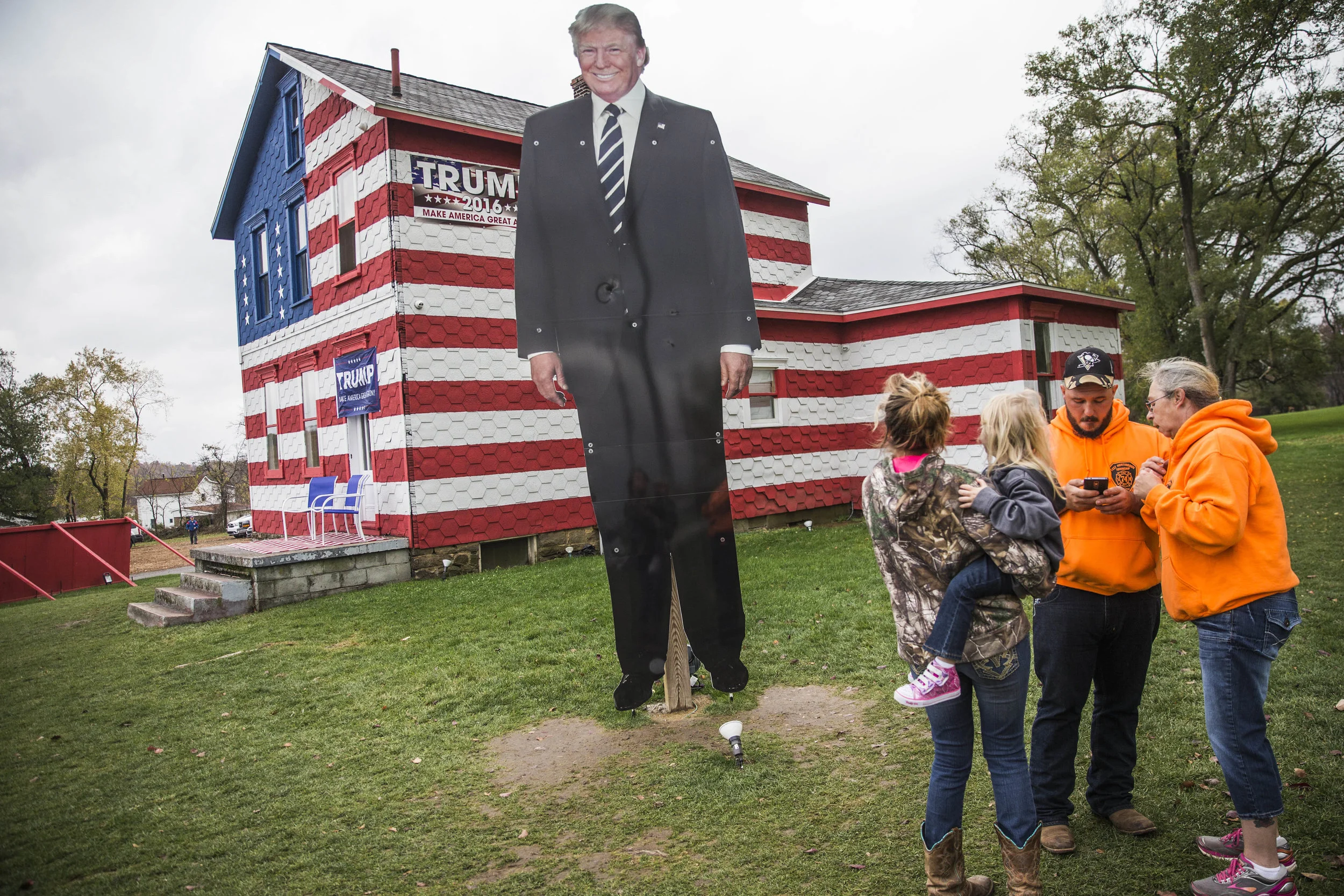 Visitors stand in front of four-meters-high Donald Trump's portrait that was erected next to the Trump House in Pennsylvania's Westmoreland county.
The building was made by Leslie Rossi, early Trump supporter, who was harassed by her neighbours for her views. In a response and being a realtor, she turned one of her houses into a self-established campaign offices, giving out 'Make America great again' merchadize and registering voters.