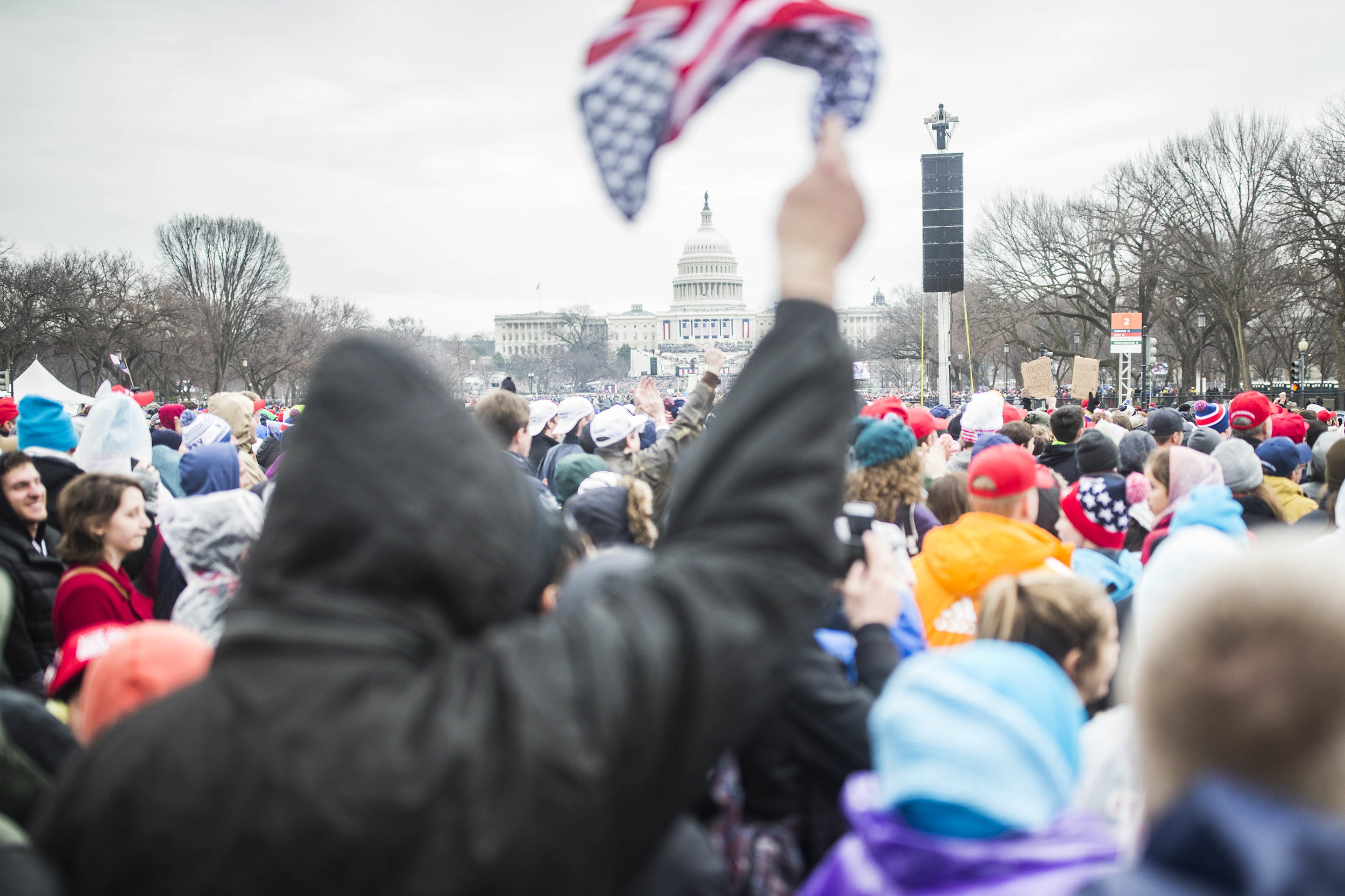  A supporter waves an American flag at the National Mall as Donald Trump is sworn in as the 45th president of the US on January 20, 2017 