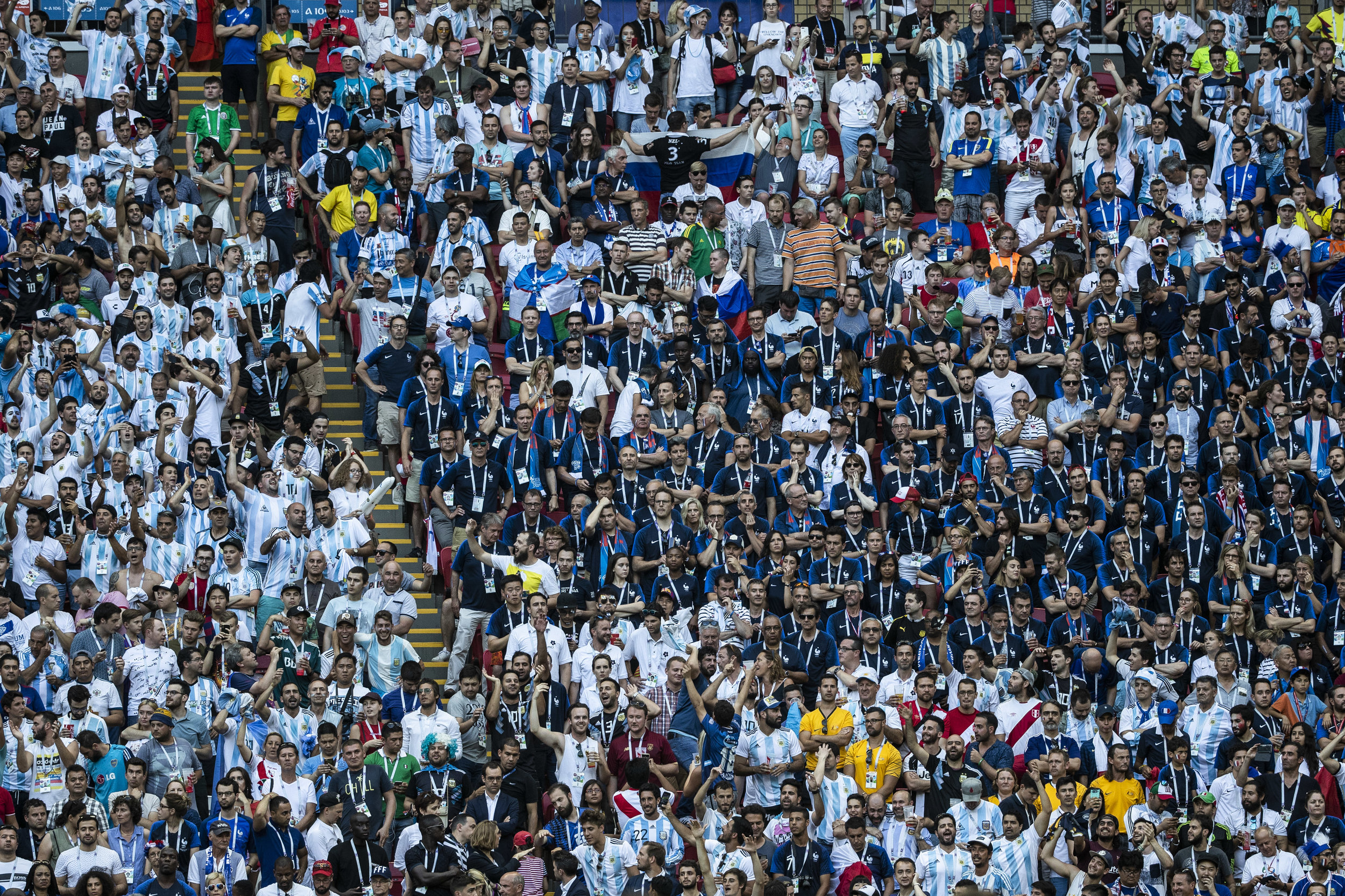  Argentinians celebrate their second goal as they surround saddened French supporters in Kazan 