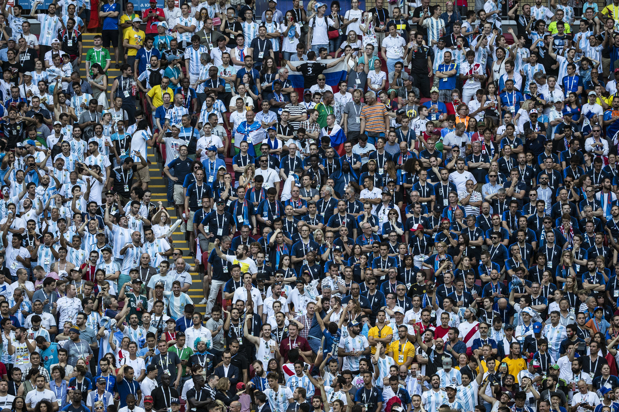 Argentinians celebrate their second goal as they surround saddened French supporters in Kazan
