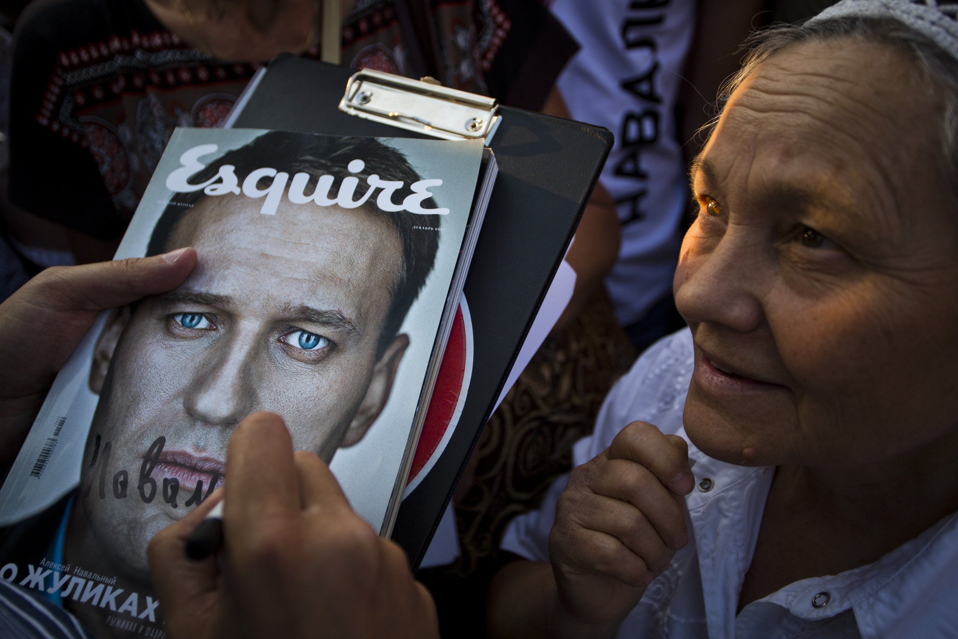  An elderly woman looks admiringly at Alexey Navalny signing autographs at a campaign event on August 21, 2013 in Moscow, Russia. Navalny ended up second in the mayorship race, getting 27% of the votes, an unprecedented share for an anti-Kremlin cand