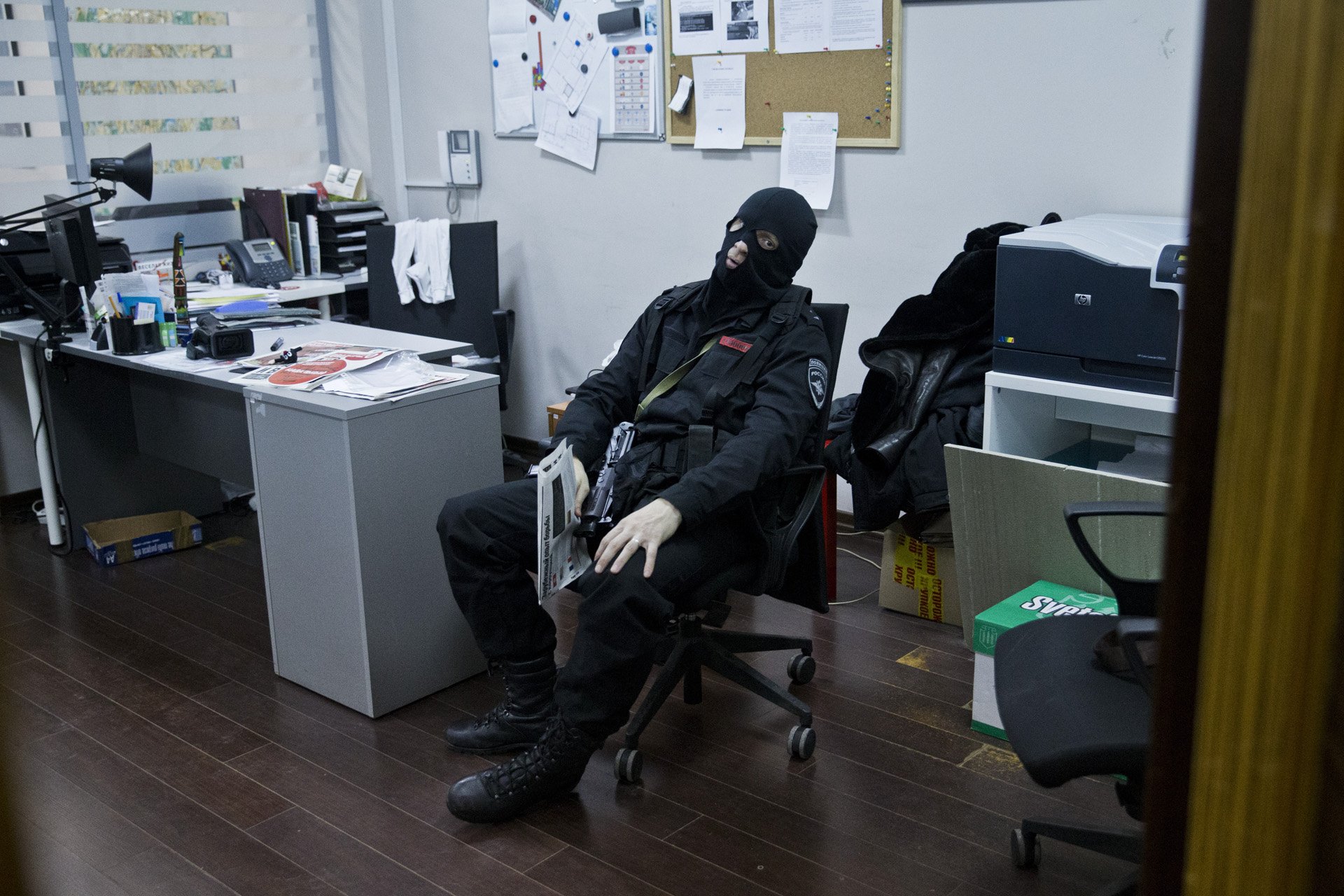  Armed police officer looks at the media gathered outside at the entrance of Anti-corruption foundation led by Alexey Navalny as its office is being searched on January 16, 2015 in Moscow, Russia.This is a news photo, shot without any influence over 