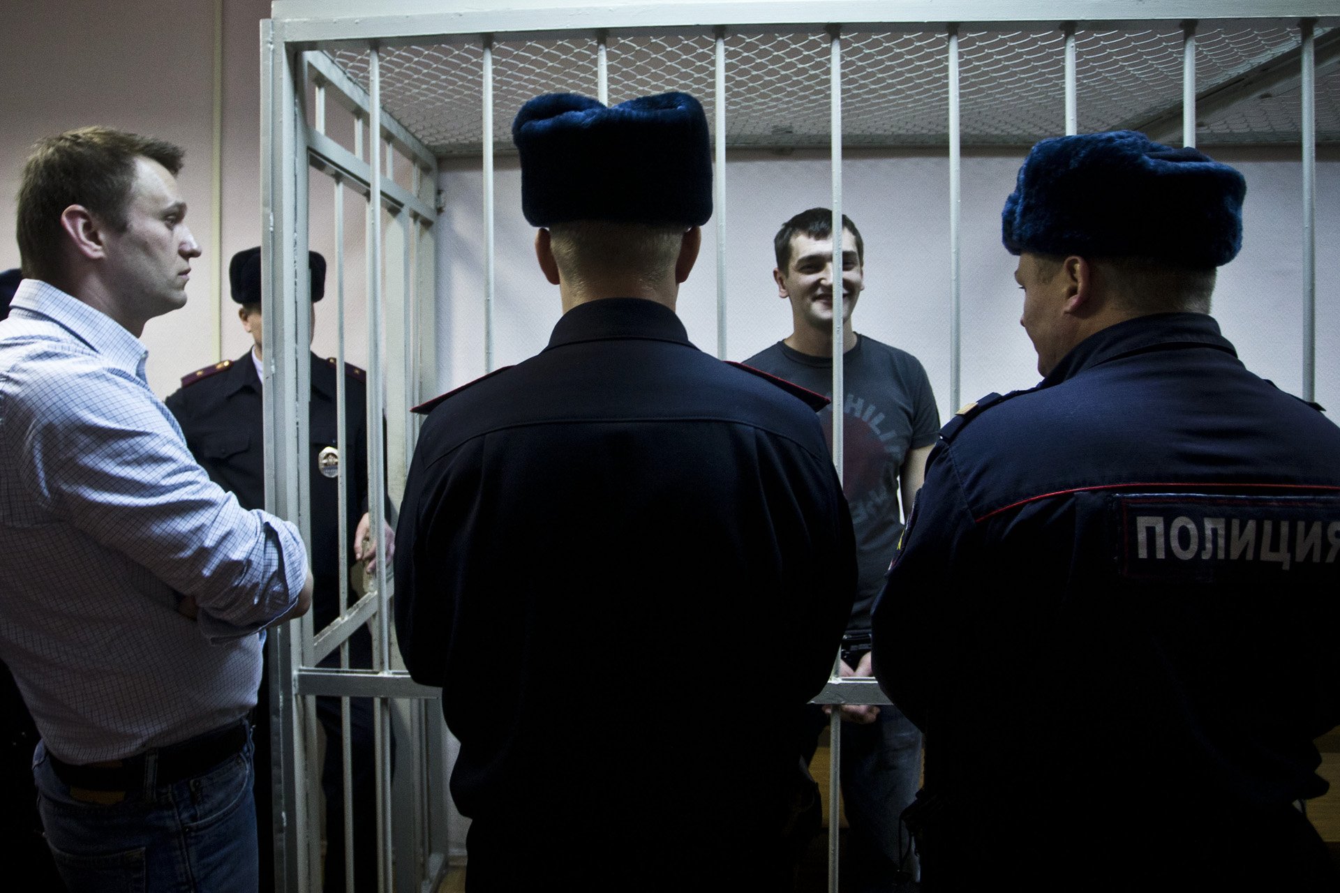  Alexey Navalny looks gloomly at his brother Oleg, who was placed in a court cage in Moscow, Russia on December 30, 2014. Both brothers were found guilty of fraud in another trial based on charges later overturned by the ECHR. Oleg was sent to a pena