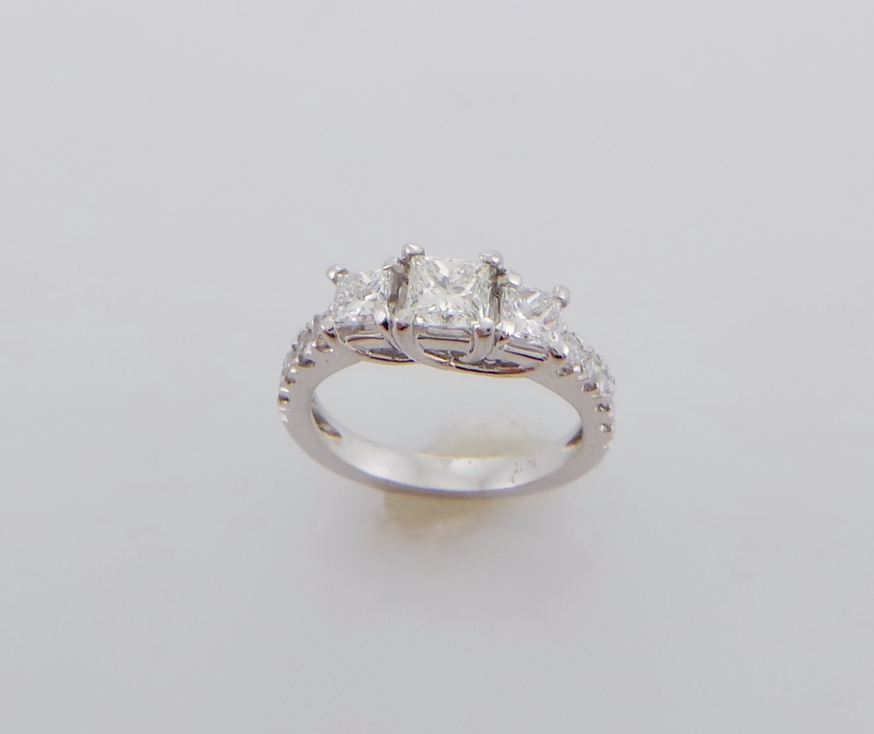 Three stone princess cut diamond engagement ring