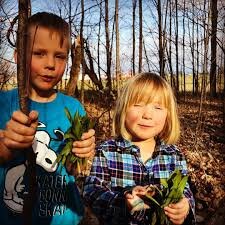 My two kids, wild leeks in hand.