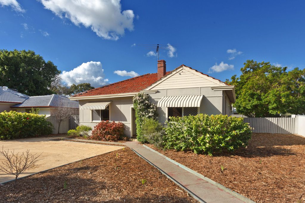 Our house when we bought it - lots of mulch, beautiful Asbestos fencing, some random seedlings around the place and lots of shrubbery against the exterior (which we pulled out almost immediately to access the stumps)