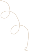 Close-up of a white, curly ribbon or string on a black background.