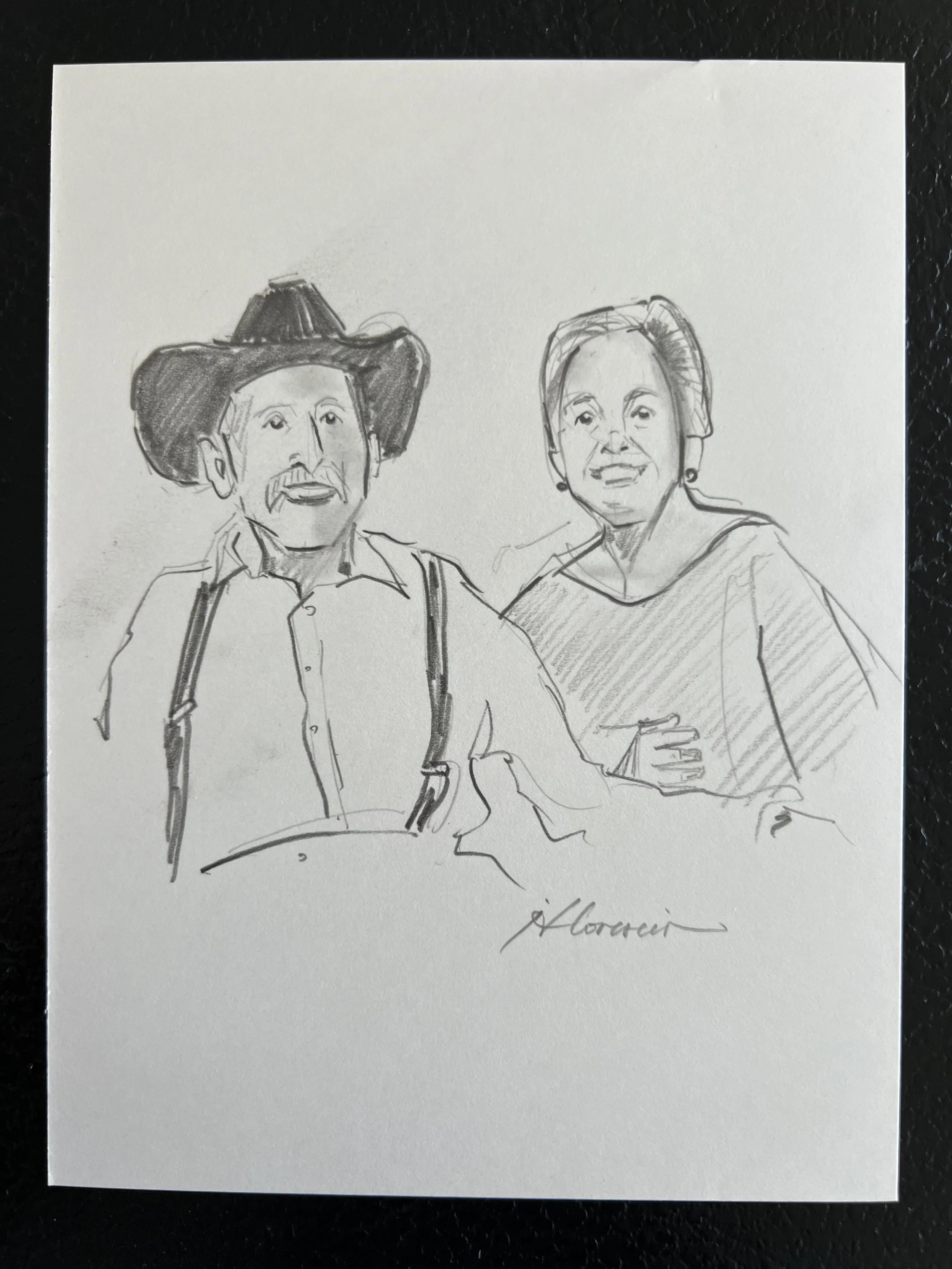 A pencil sketch of a man wearing a large cowboy hat, a collared shirt, and suspenders, standing next to a woman with short hair, earrings, and a top, both smiling.