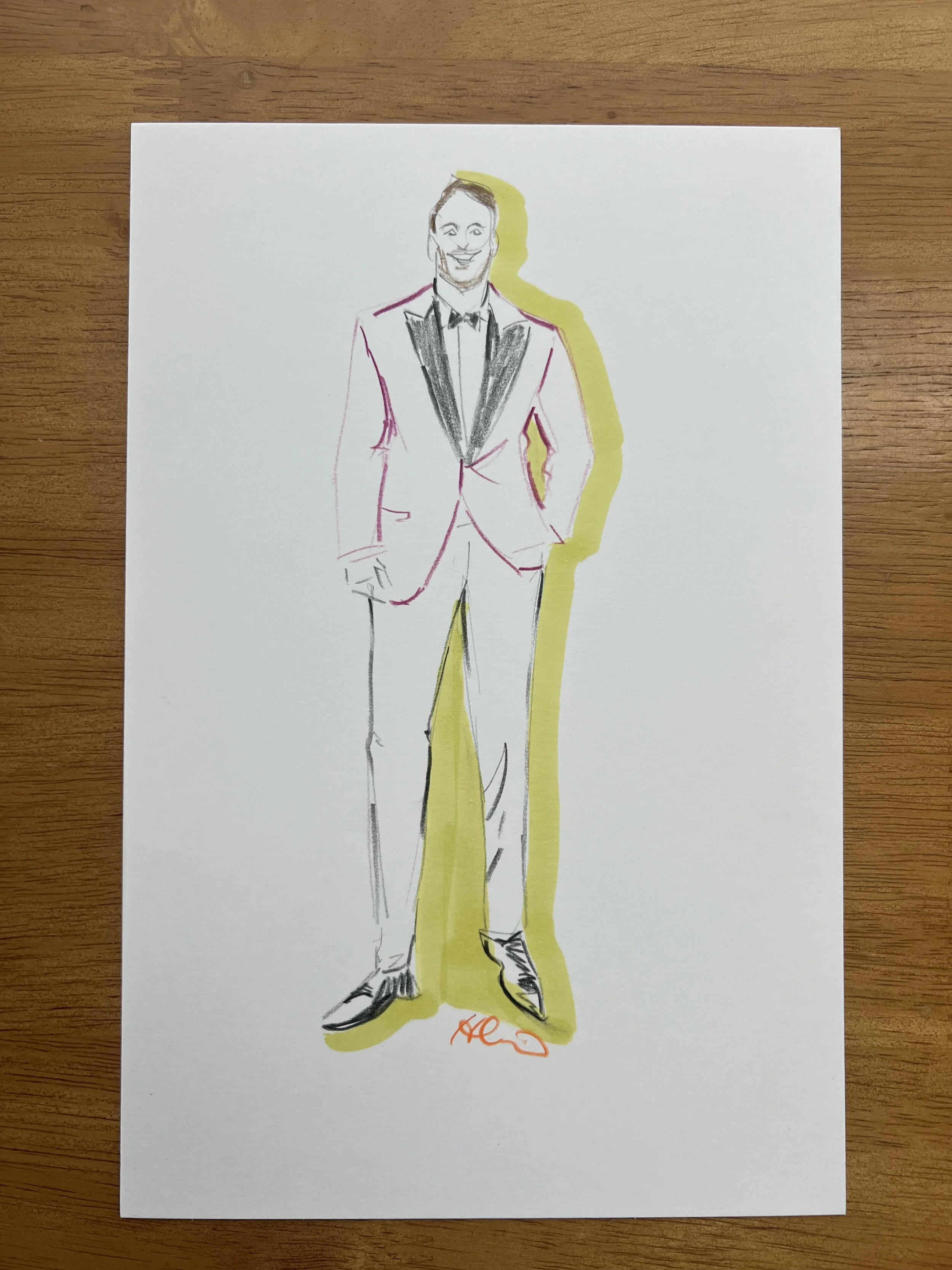 Line drawing of a man in a tuxedo with a yellow shadow behind him on white paper, signed with an orange signature at the bottom.