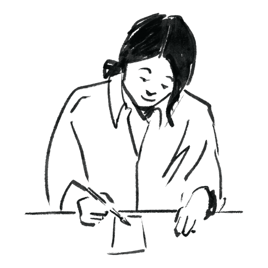 A person with blonde hair, wearing a dark shirt, leaning over a table and writing or drawing with a pen or pencil.