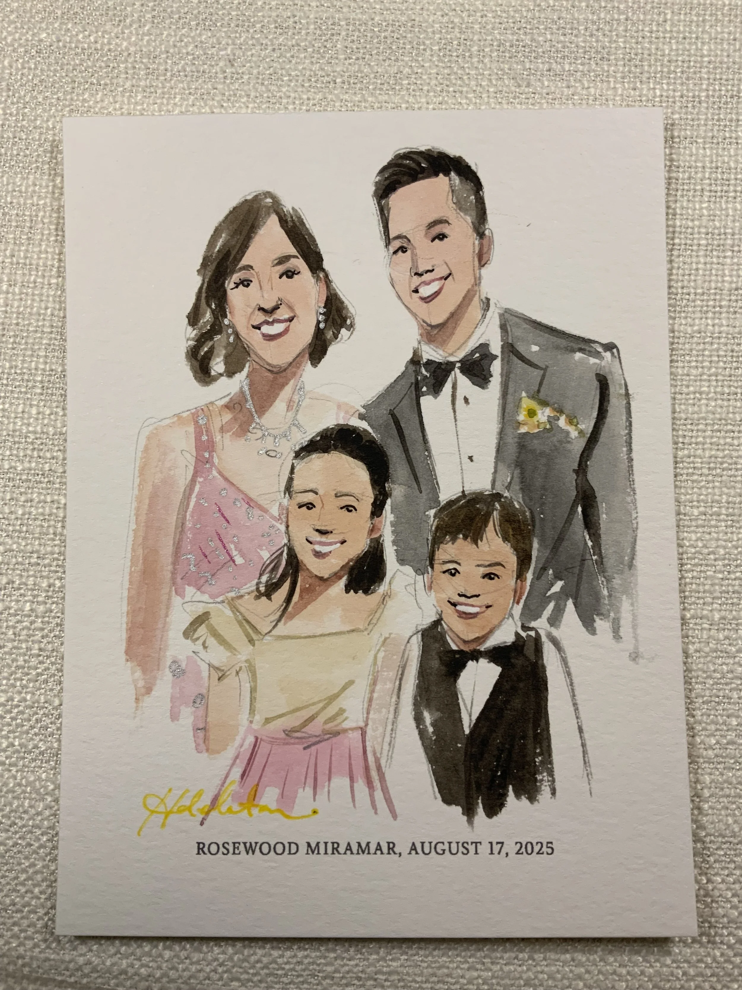 A watercolor illustration of a family of five in formal attire, standing together and smiling. The background is plain, and the illustration is on a card with the text 'ROSEWOOD MIRAMAR, AUGUST 17, 2025' at the bottom.