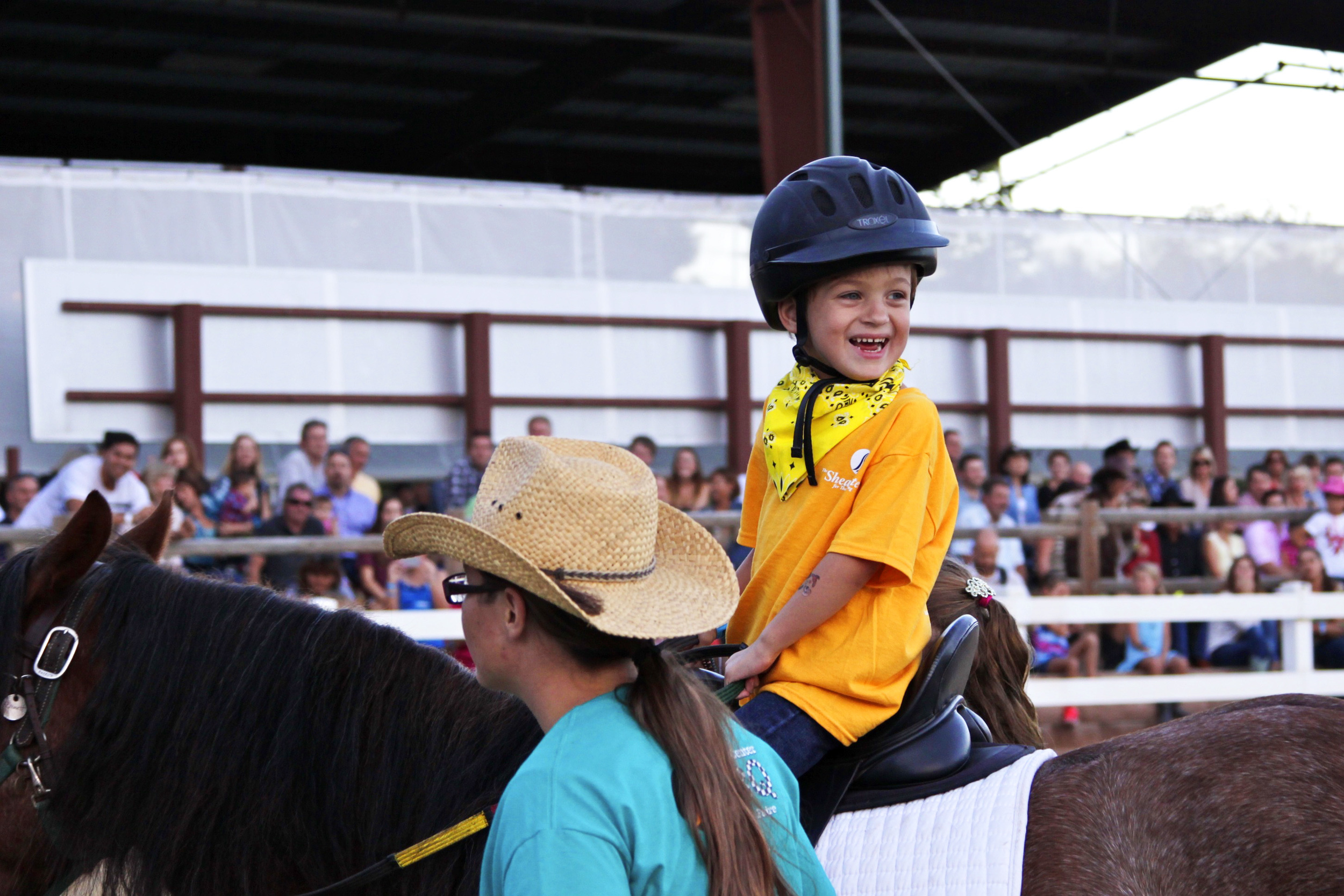 Smiling Child Riding a Horse