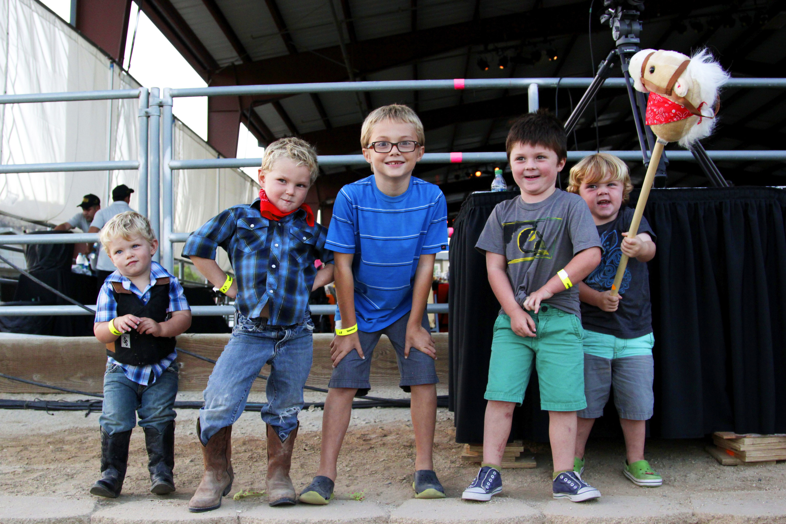 Multiple Kids outside of an Animal Pen