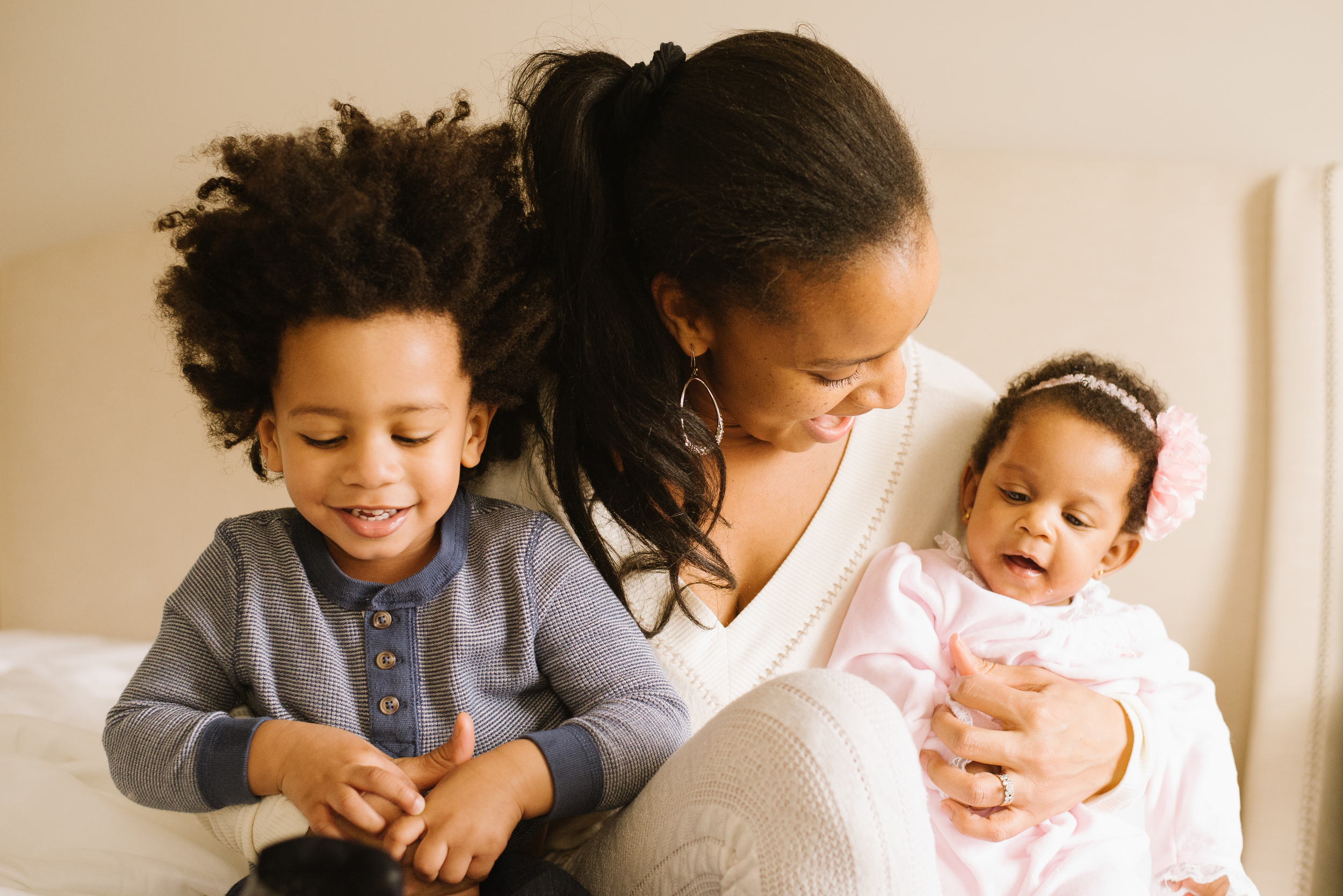 During an in home session in Aylesbury, Oxfordshire, Mum holds bother her children during their family photography session.