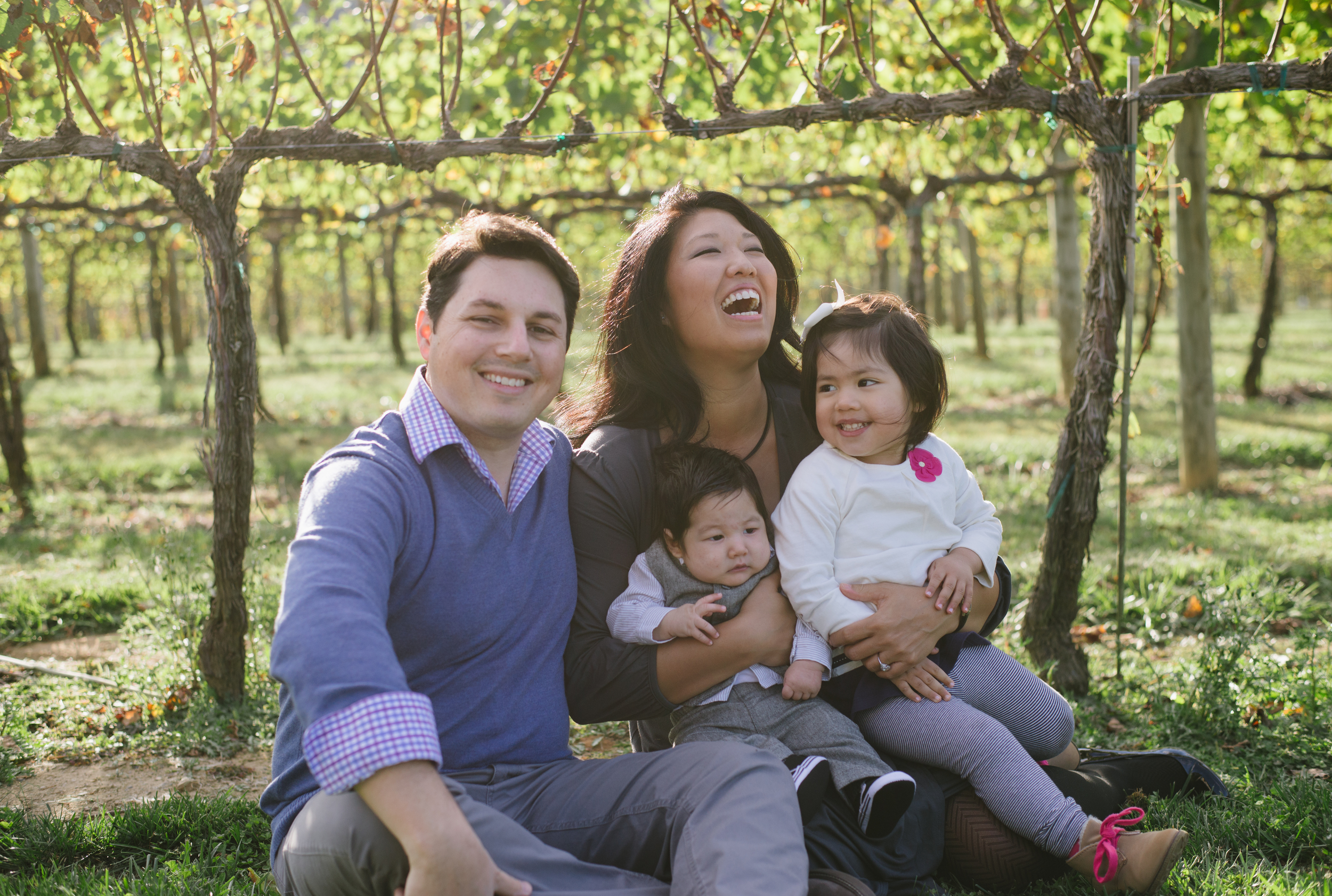 Family laughs together during their session outside a vineyard near Northhampton.