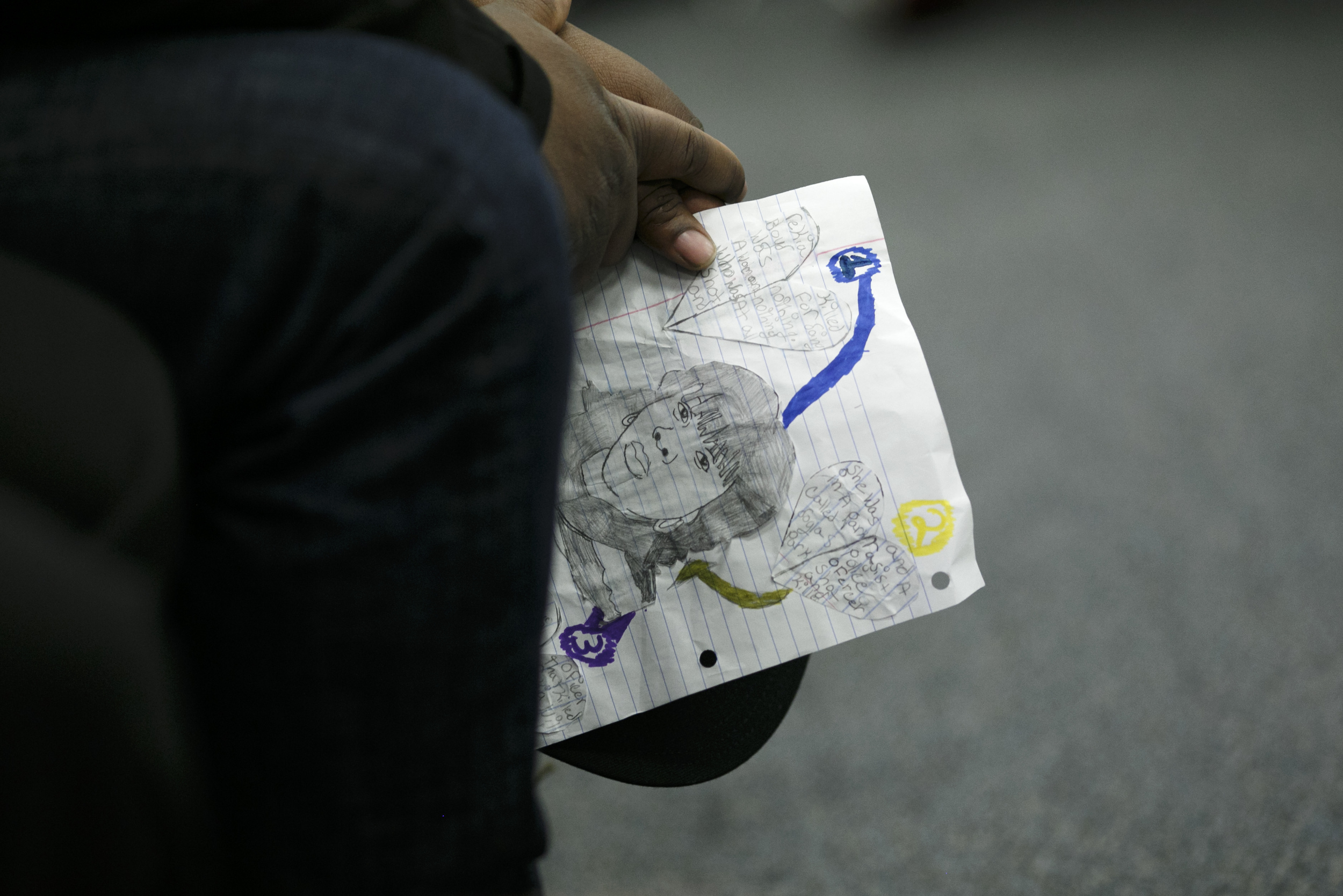 Martinez Sutton holds an illustration of his slain sister, Rekia Boyd, during the November Police Board Meeting. (Jonathan Gibby/City Bureau)
