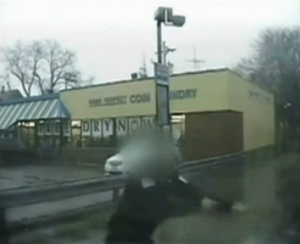 The dashcam video from Ruth Castelli’s police vehicle reveals the moment when the officer, shown here with her face blurred, pulled her gun on Jamaal Moore. (NBC 5)