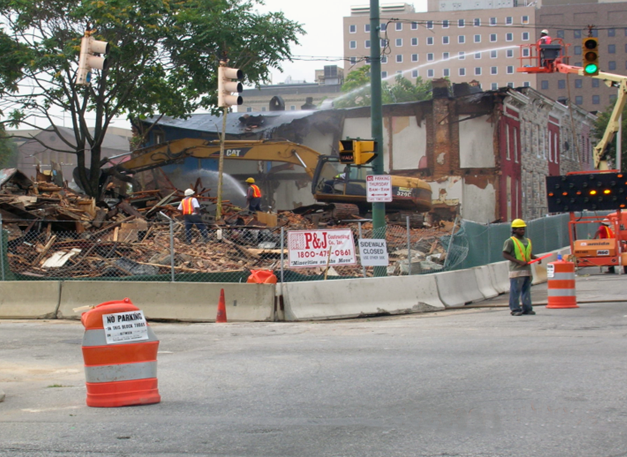 In order to reduce exposure to harmful dust, workers suppress dust by wetting down the debris (Courtesy David Jacobs).