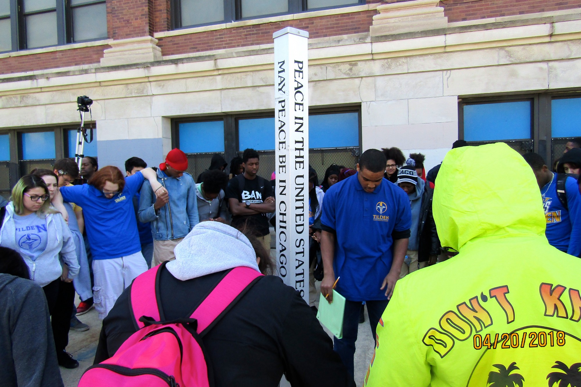 Tilden Career Community Academy students gather around the school’s “peace pole” April 20 for the National School Walkout. Photo by Samuel Davis.