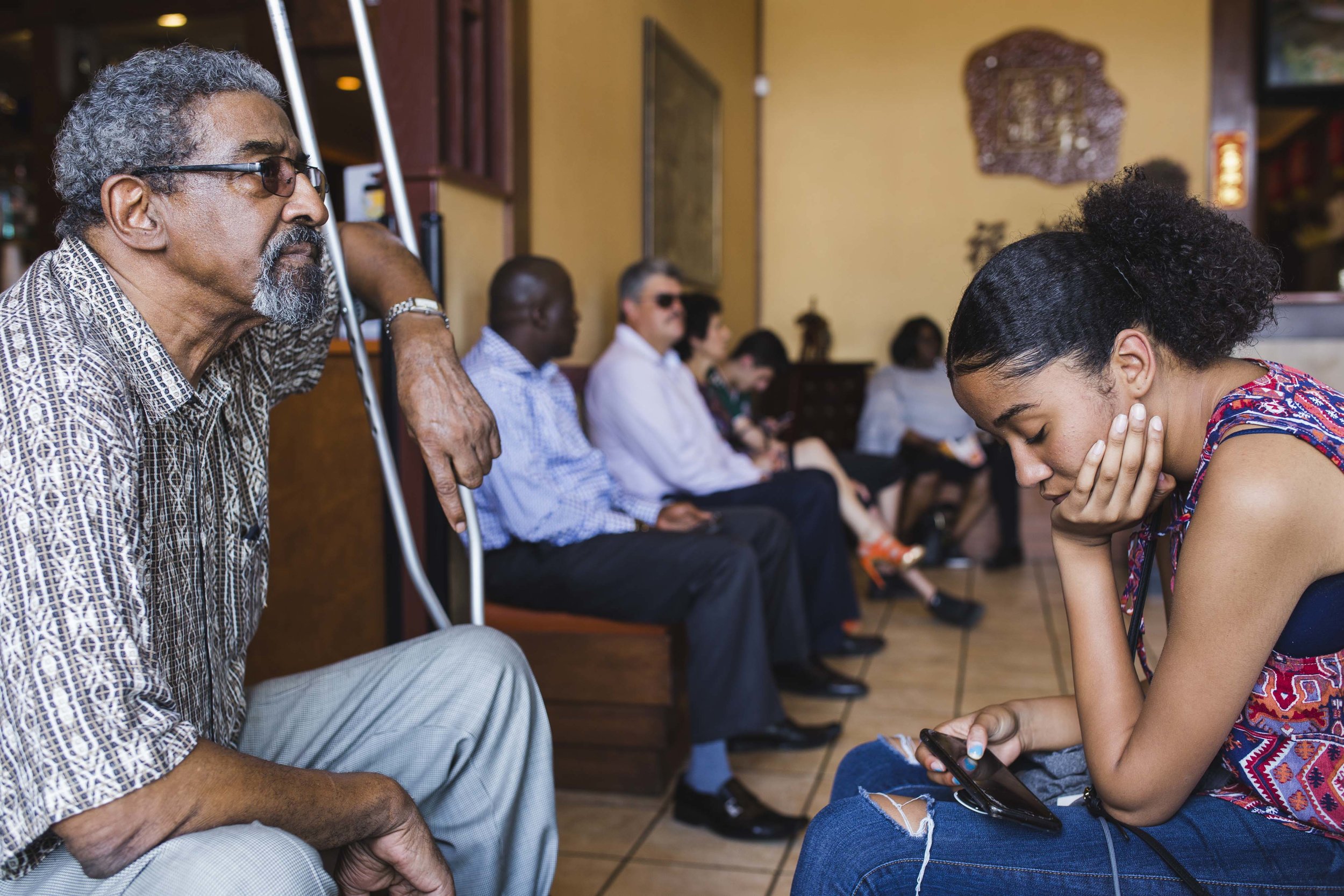  On Father’s Day, Carlton Brown, 72, waits for a table while his 13-year-old daughter has her eyes glued to her phone. “It is challenging to keep up with technology and the changing system,” said Brown. Often, he feels like he is “on the outside look