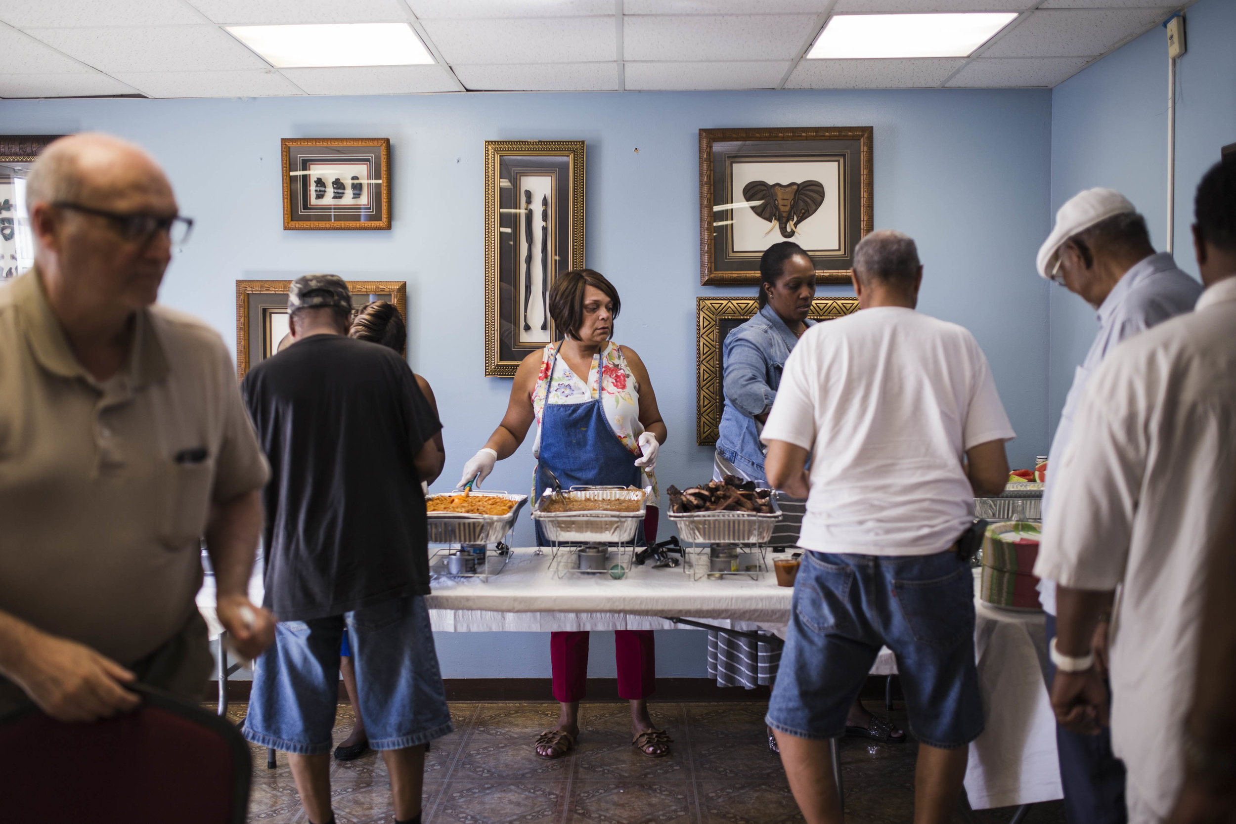  Becky Clark, service coordinator of New Pisgah Haven Homes in Auburn Gresham, serves food during the senior building’s Father’s Day Cookout. “They kids, they’re all busy. Every now and then you see them and then you don’t,” said Carlton Brown, 72. B