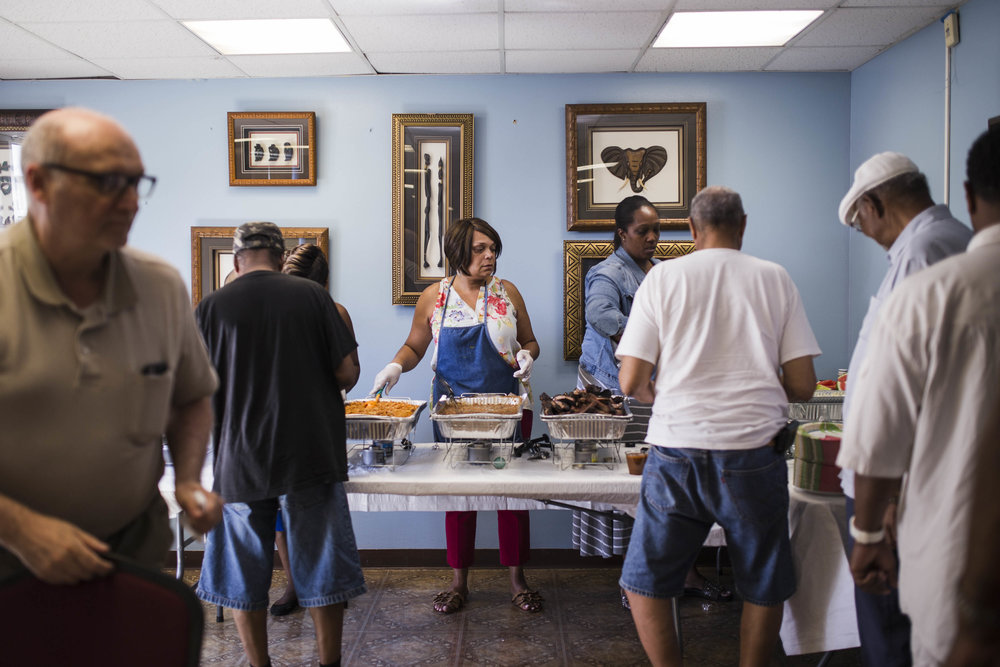  Becky Clark, service coordinator of New Pisgah Haven Homes in Auburn Gresham, serves food during the senior building’s Father’s Day Cookout. “They kids, they’re all busy. Every now and then you see them and then you don’t,” said Carlton Brown, 72. B