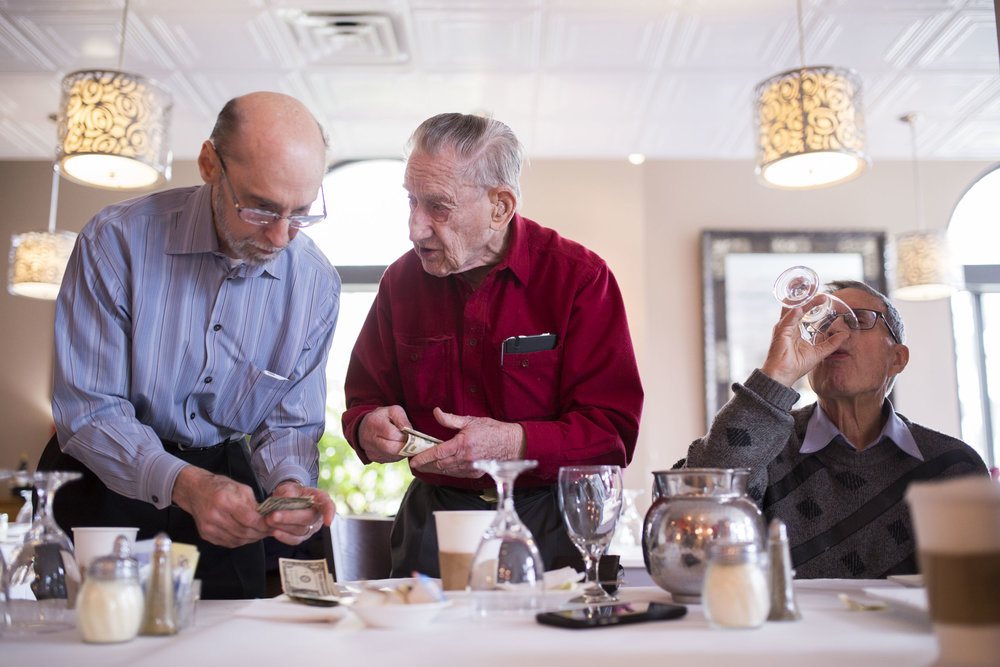  Jerry Gripshover and Sam Guard leave a tip at Piccolo Mondo in Hyde Park. Gripshover and Guard are part of a men’s group composed of Hyde Park residents that meet at least twice a month to socialize. Social isolation among older adults is one of the