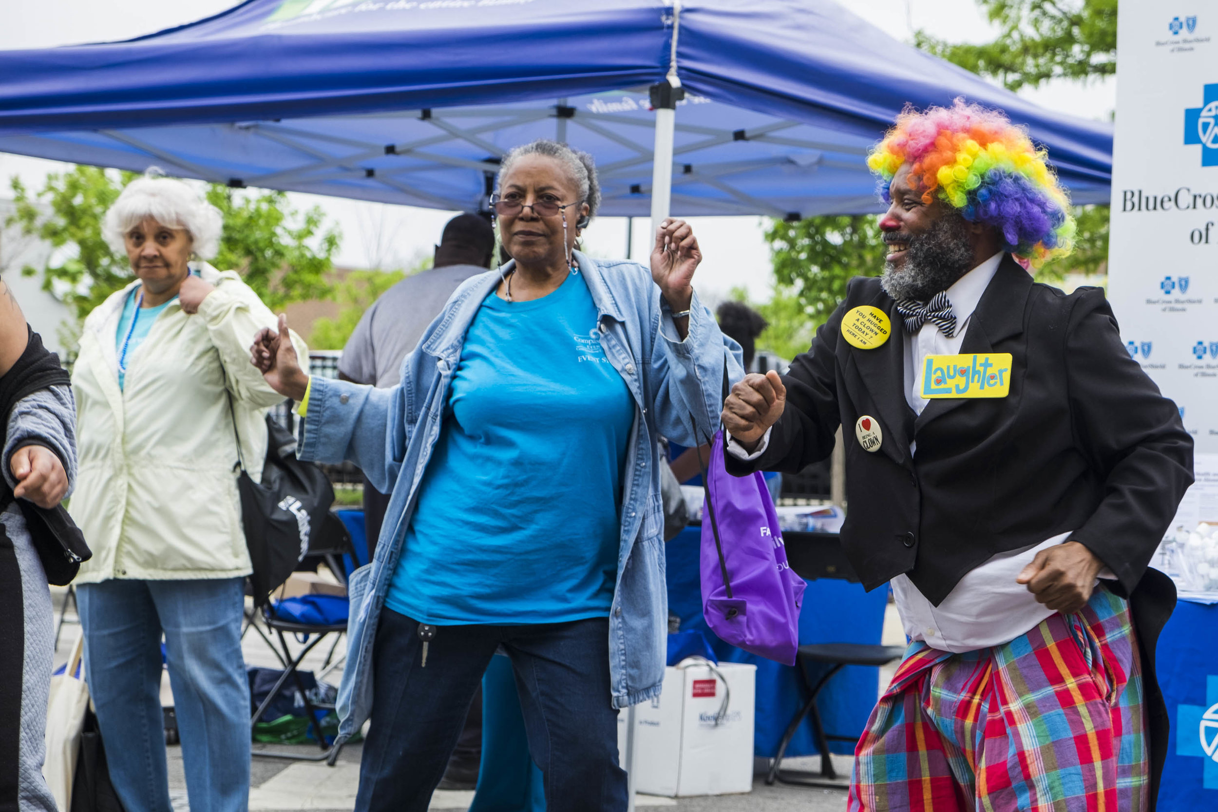  Antonio Sanders, a member of the Senior Clown Troupe, dances with older adults during the Englewood Exclusively Us Senior’s Day Celebration. Sanders and the Senior Clown Troupe performs for older adults in nursing homes and retirement centers. “Clow