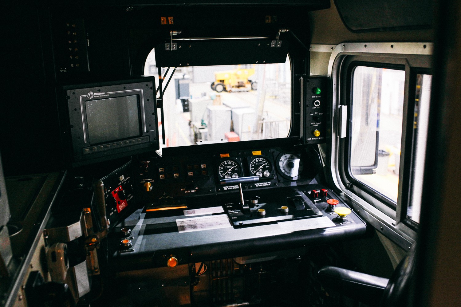 The interior of the conductor's seat of the newer cars on the Metra Electric, which sits higher than the cars from 1972. This means the conductors can see more of the rails in front of them.