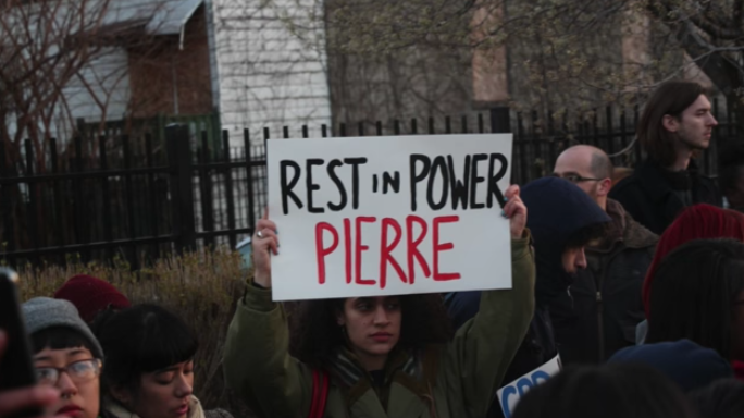 Community members gather after 16-year-old Pierre Loury was shot and killed by police in May 2016.