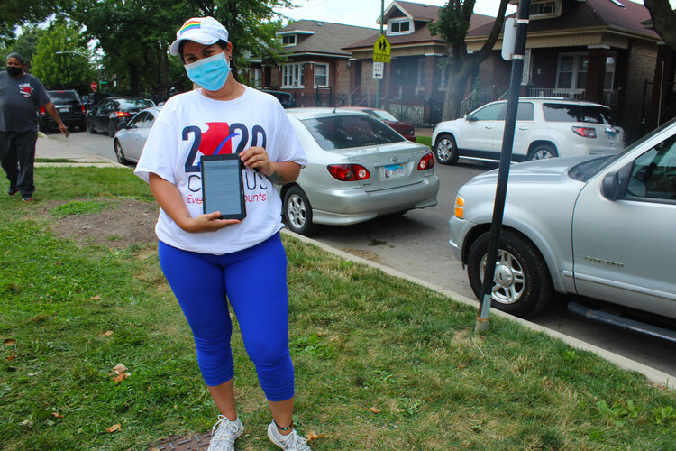 Maribel Sanchez, a volunteer with the Brighton Park Neighborhood Council, volunteered at a food distribution site before approaching people in line to count them in the census. (Photo: Alexandra Arriaga)