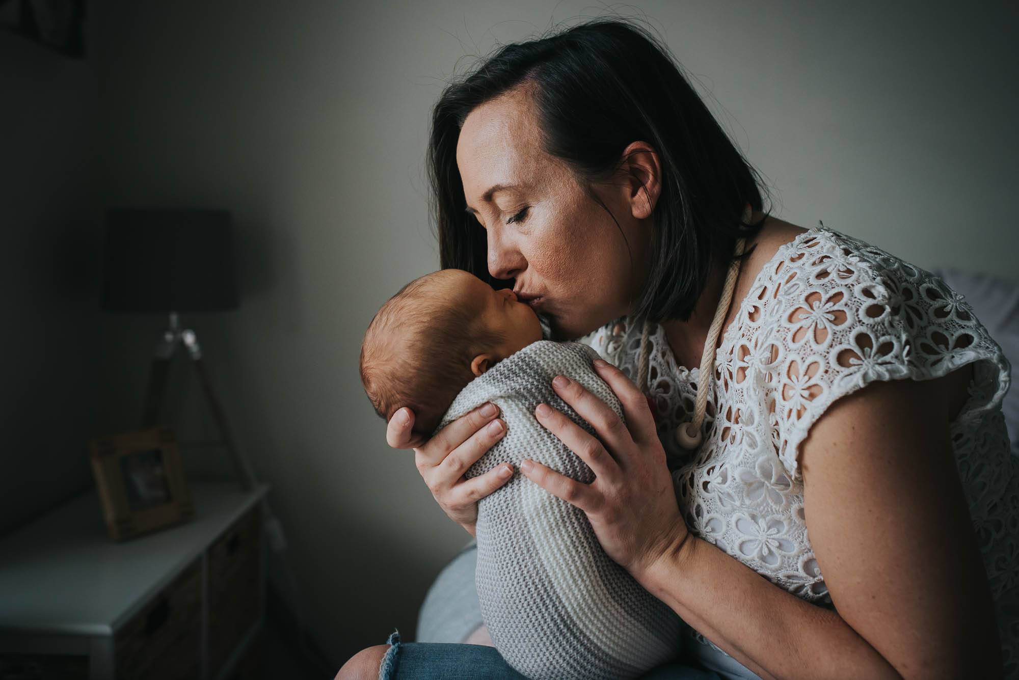 mum kissing newborn baby at a newborn photo session