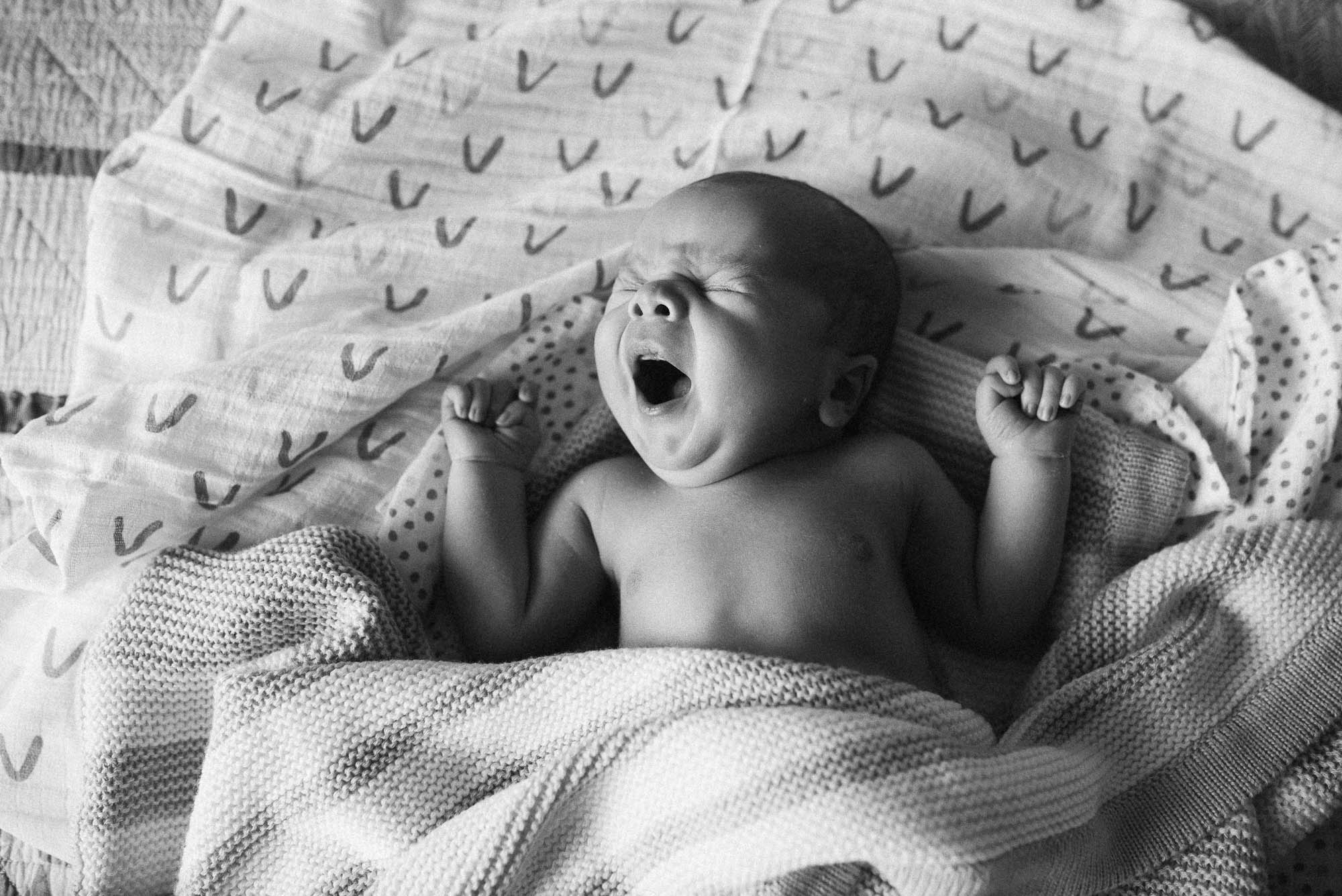 newborn baby yawning at a lifestyle newborn photo session