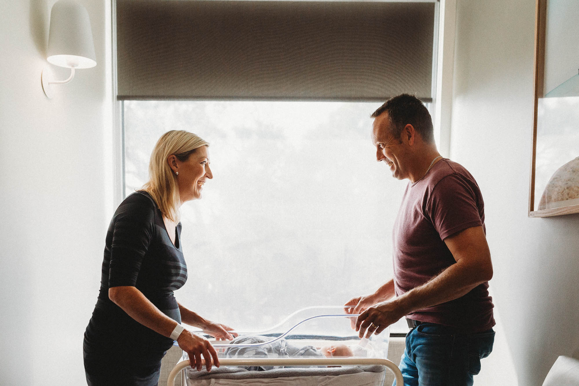 parents-looking-at-newborn-in-bassinet-at-hospital-melbourne