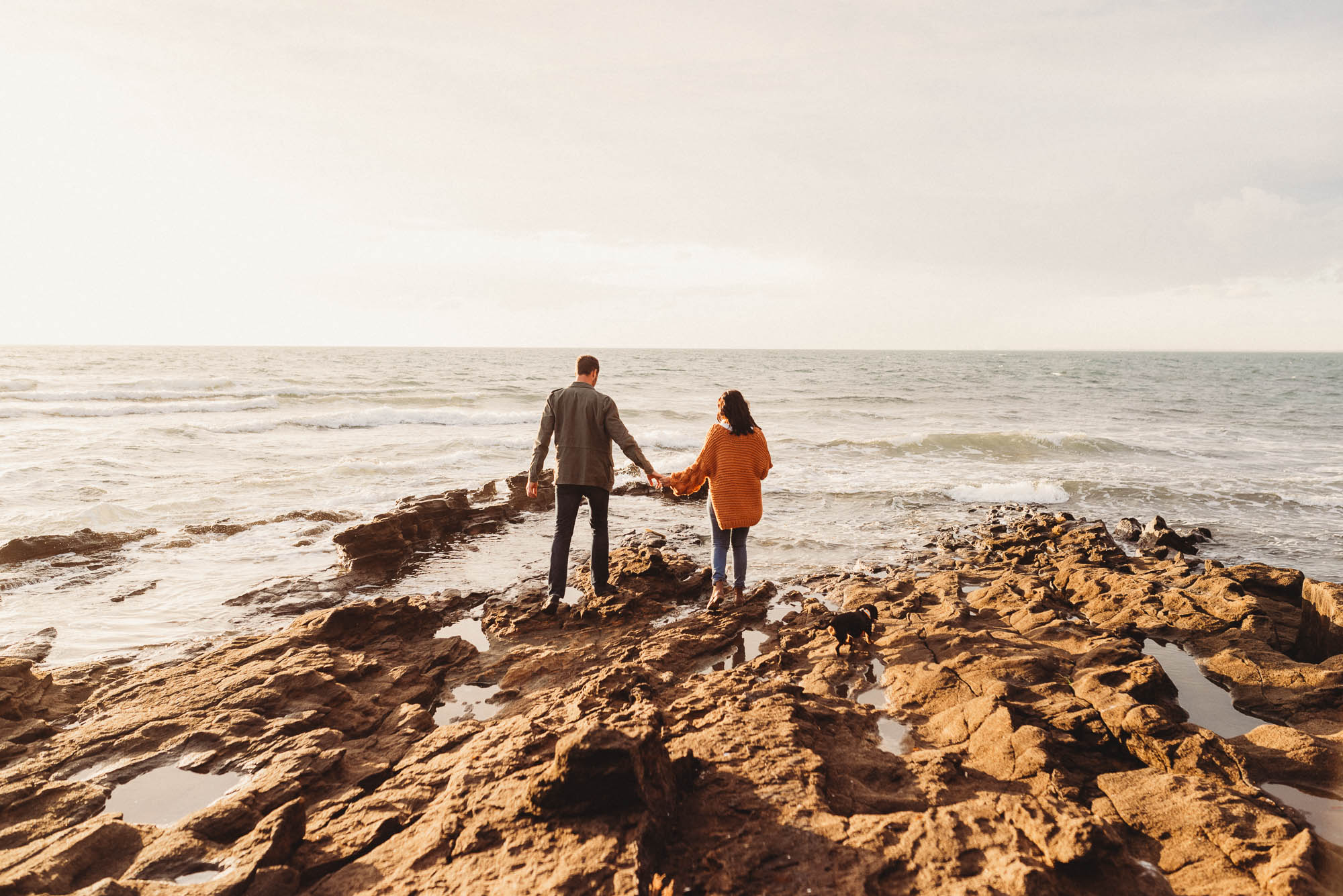 melbourne_maternity_photographer_jenny_rusby_photography_couple_standing_together_on_the_rocks_at_the_beach